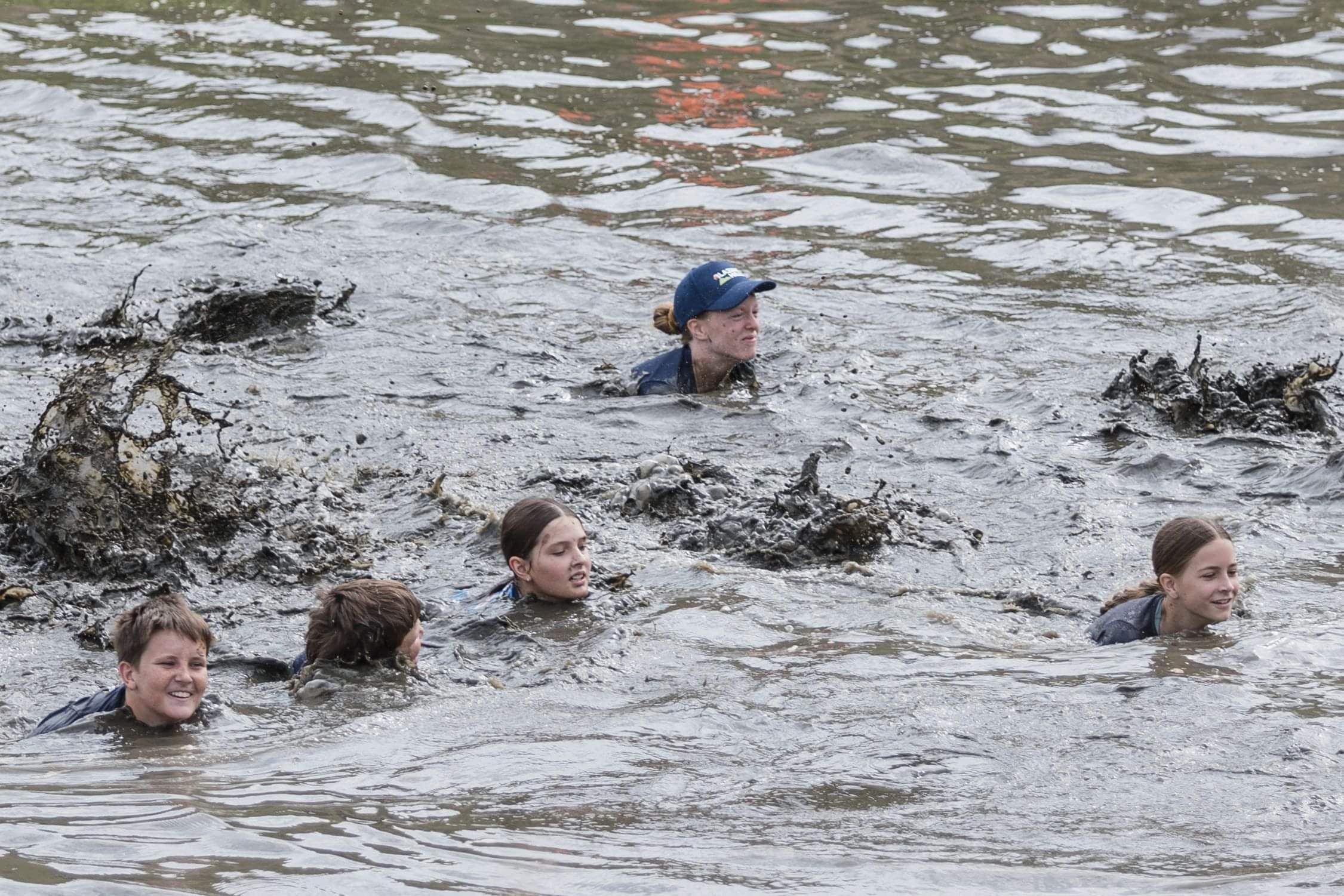 The event hub with people relaxing, enjoying home cooked food, a refreshing drink, and enjoying the entertainment 