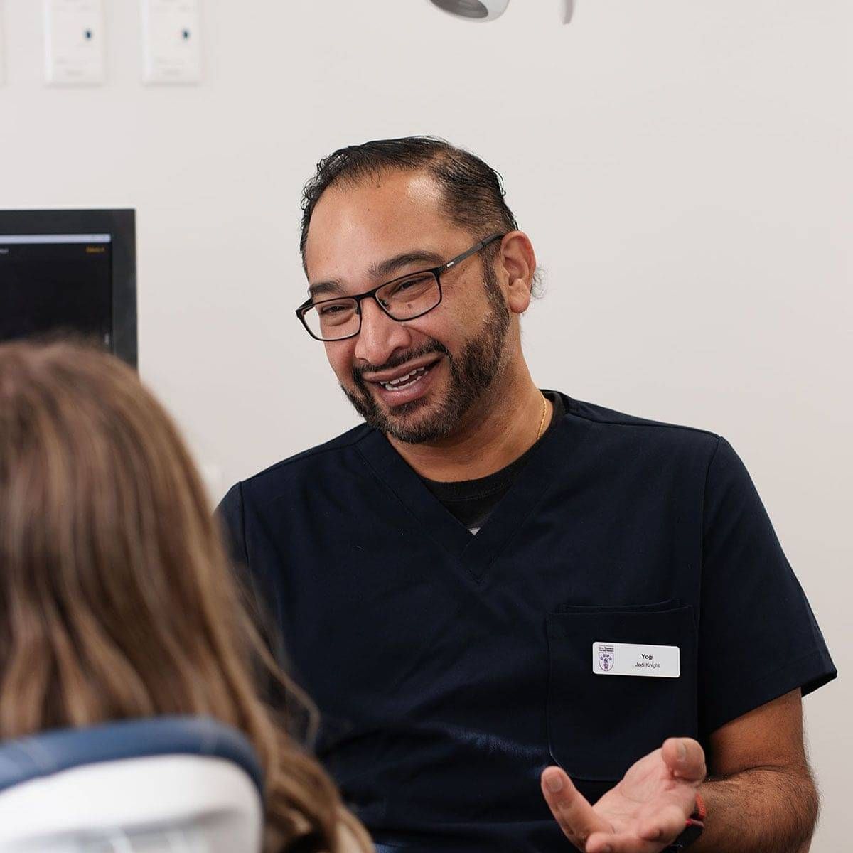Dentist Yogi talking to patient at dental check-up