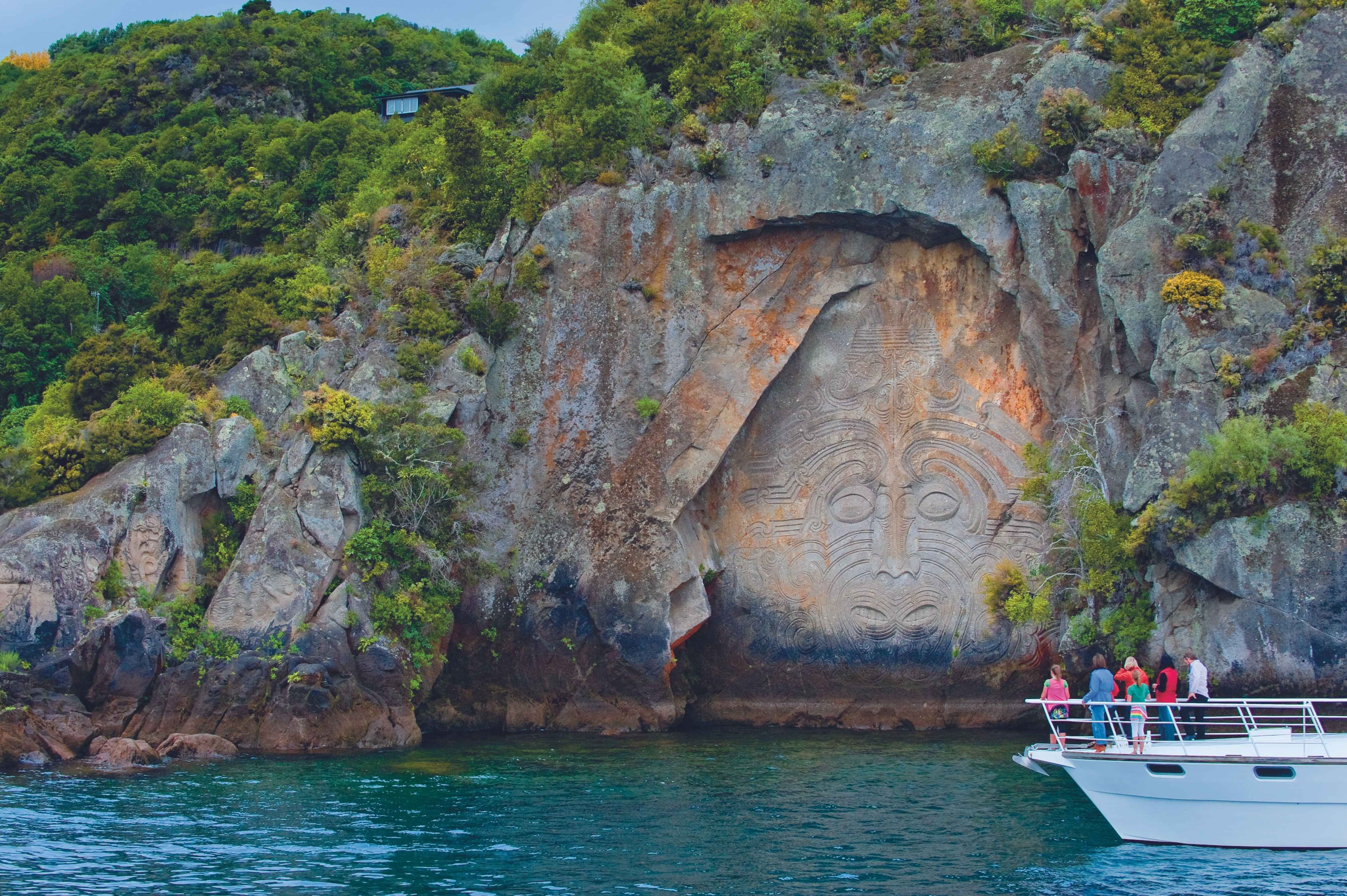 Ngatoroirangi Maori Rock Carvings at Mine Bay, viewed from a cruise boat on Lake Taupo