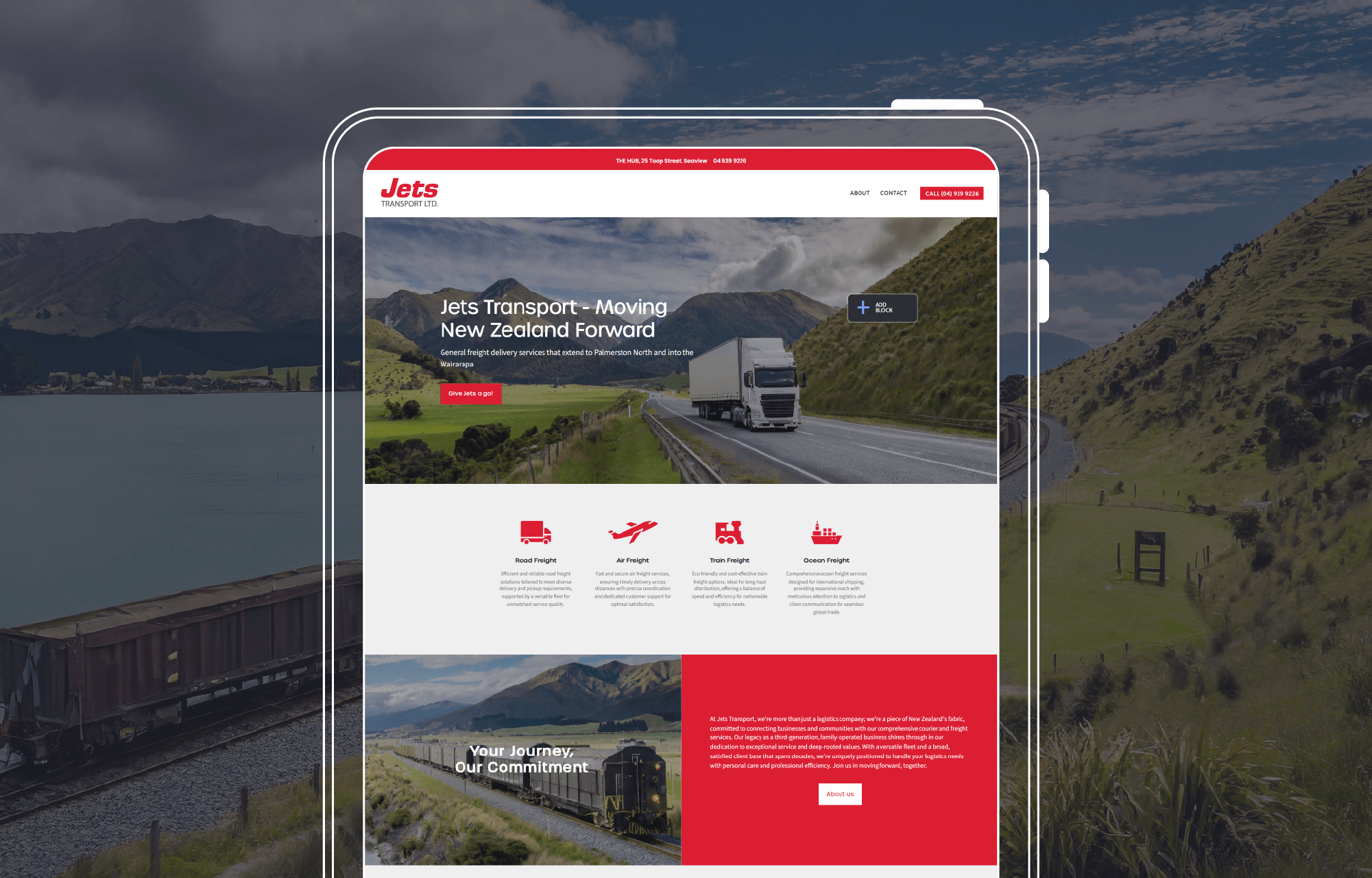 Tablet displaying Jets Transport homepage with a freight truck on a scenic road, overlayed on a background of a train near a lake