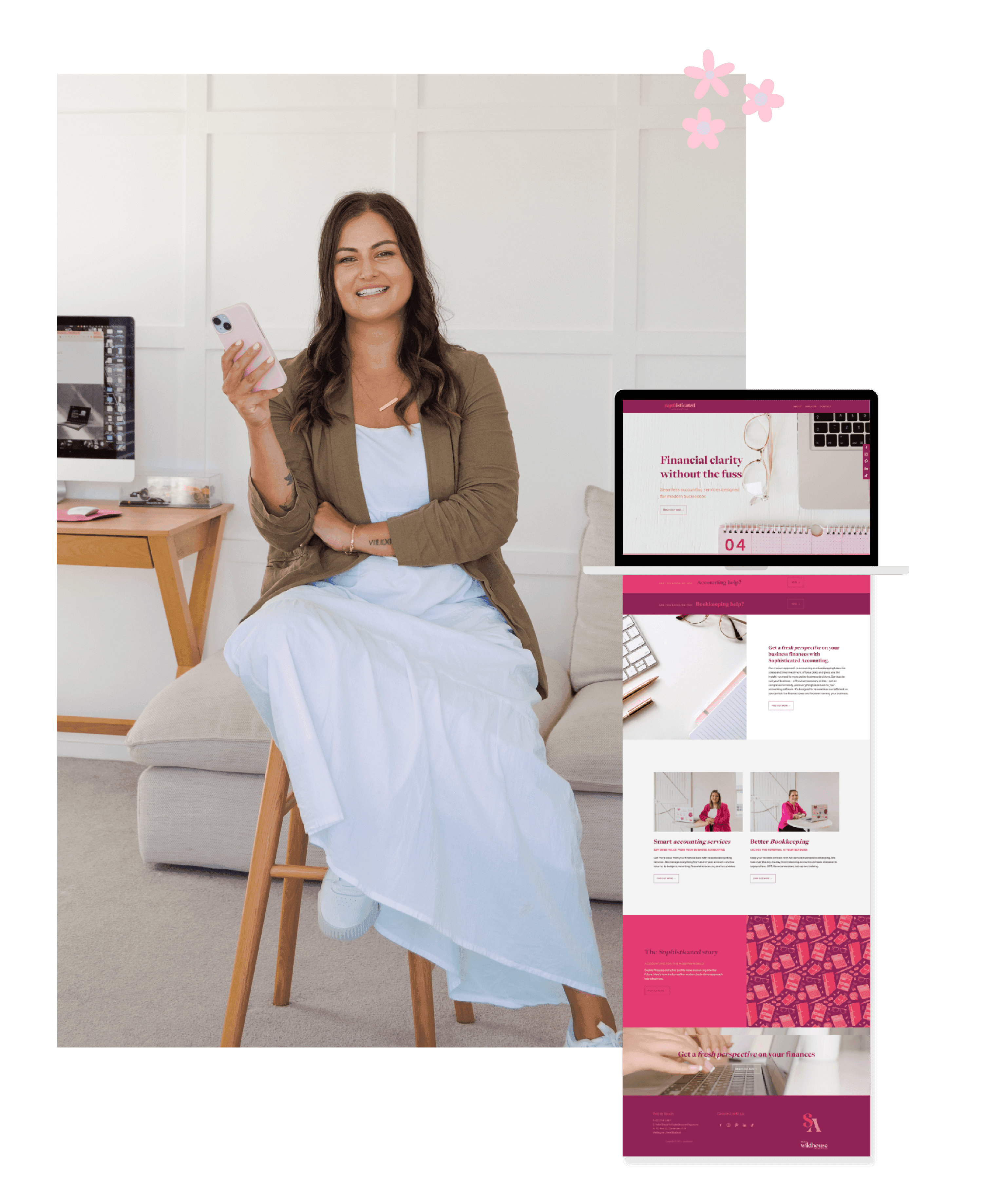Web designer seated, holding a phone, with a laptop showcasing a website design layout beside her
