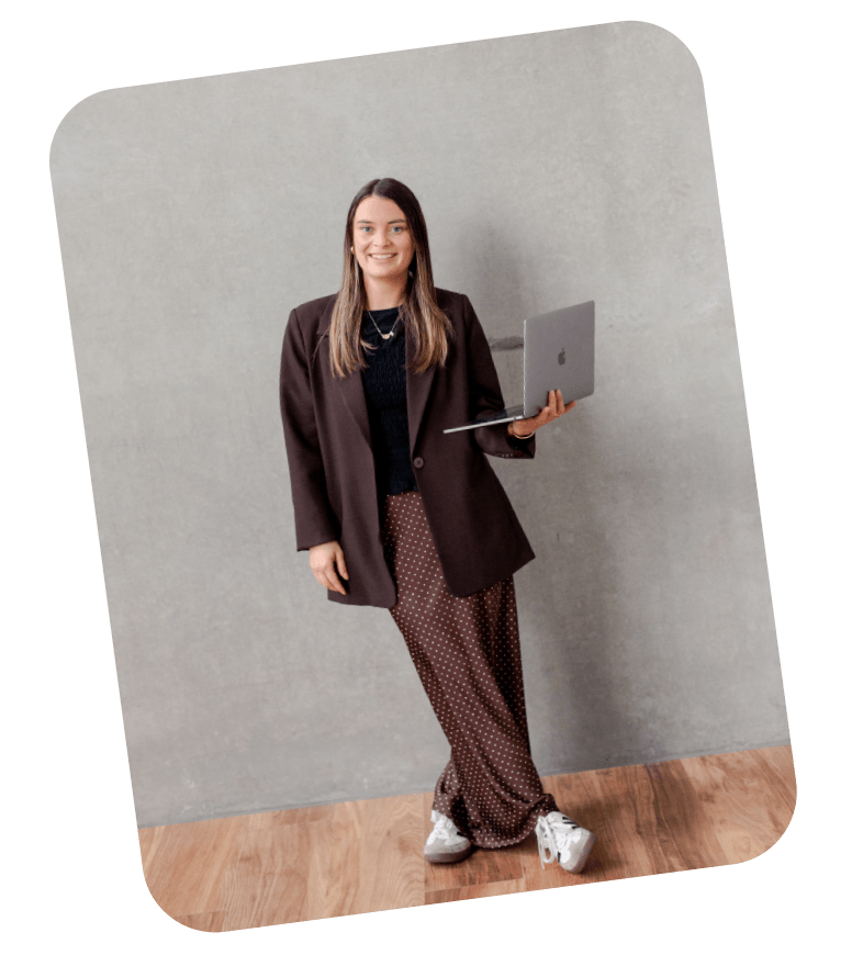 Web designer seated at a cafe table, focused on her phone