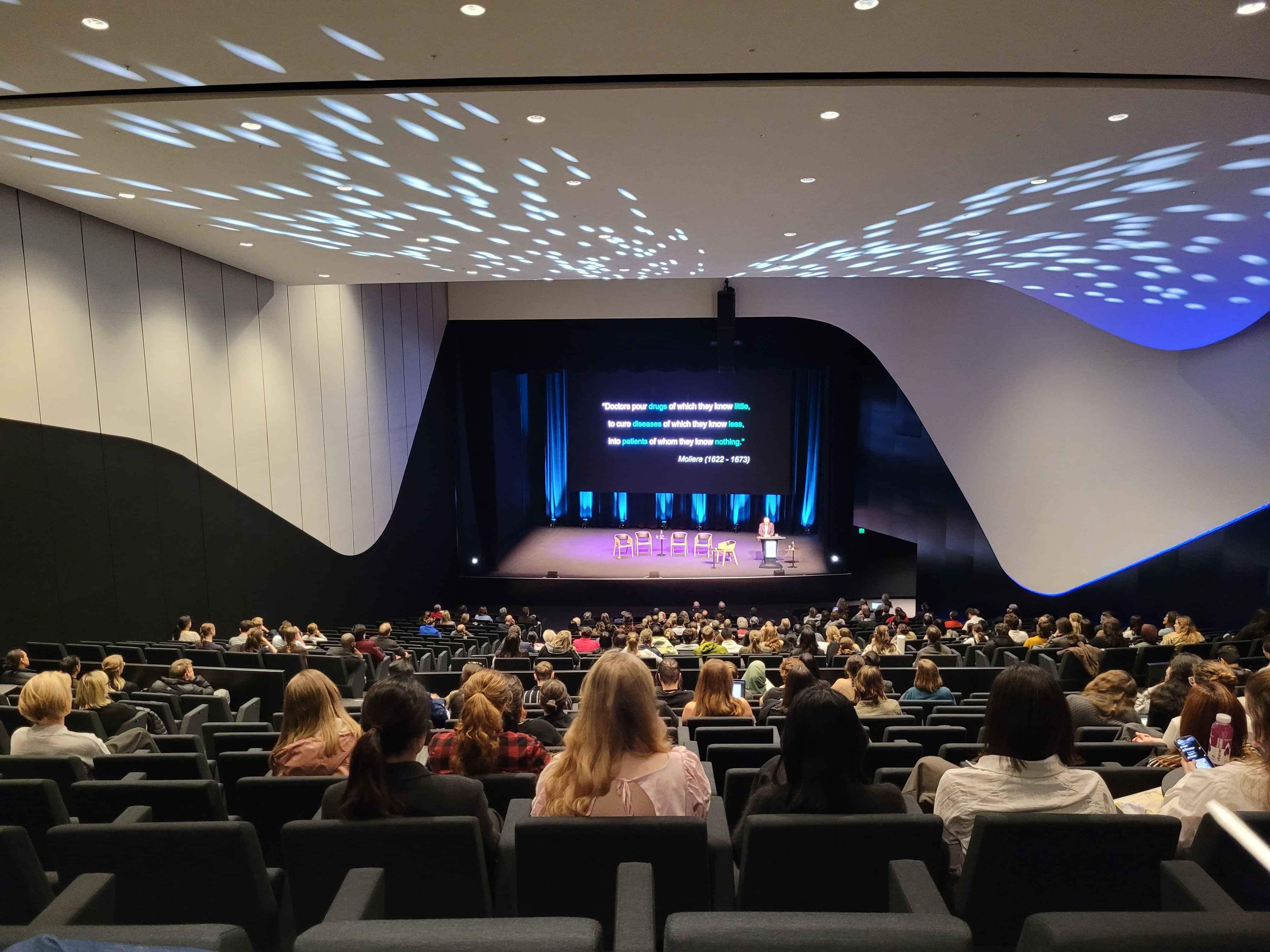 A speaker on a custom decorated stage at a conference. Part of Little Big Events Conference planning.