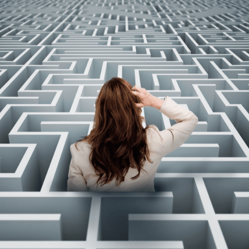 Woman stuck in maze trying to find her way to the exit