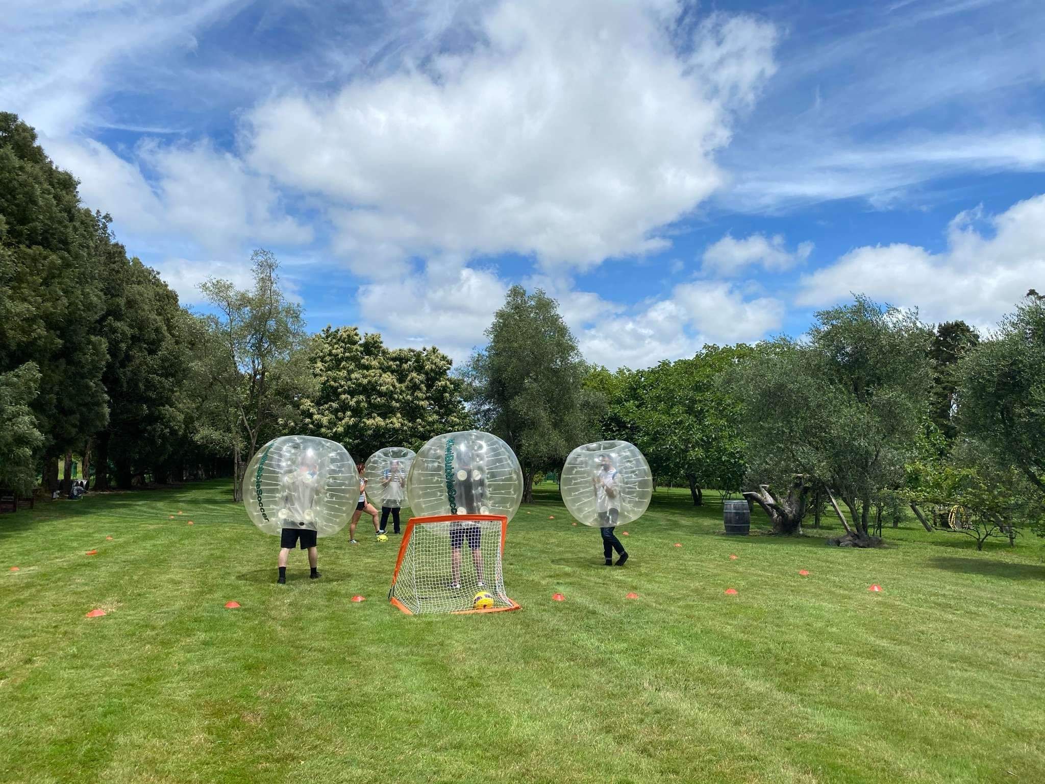 people playing football bouncing zorb balls