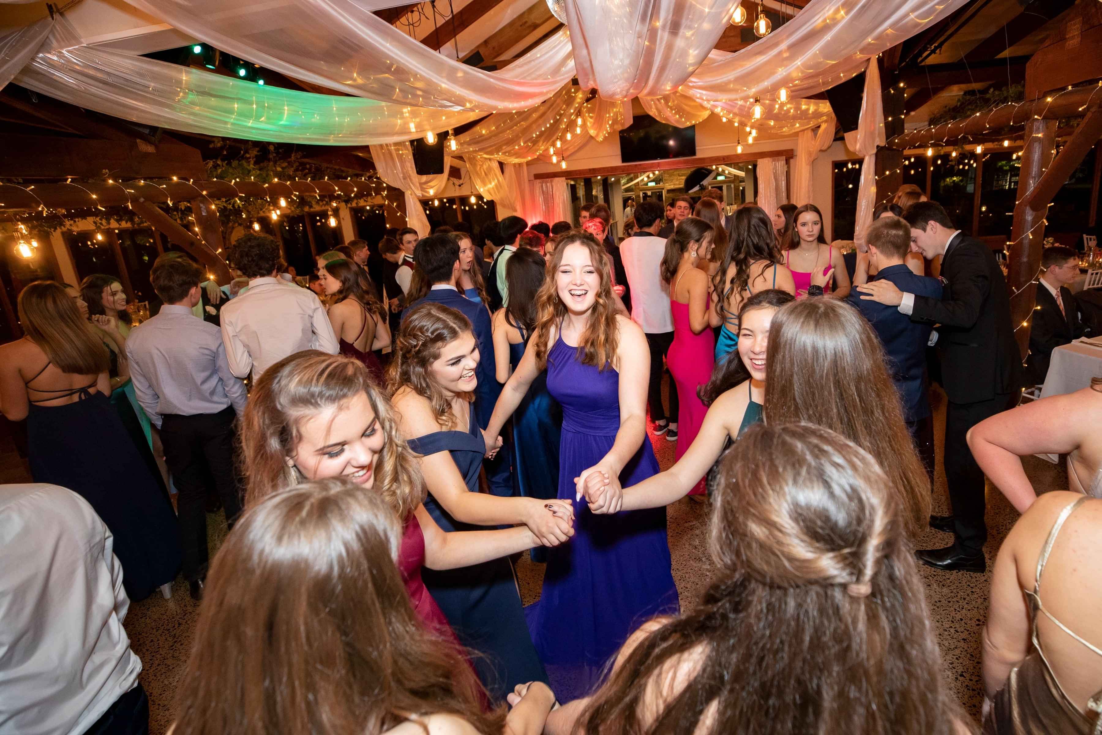 a group of girls dancing at school ball