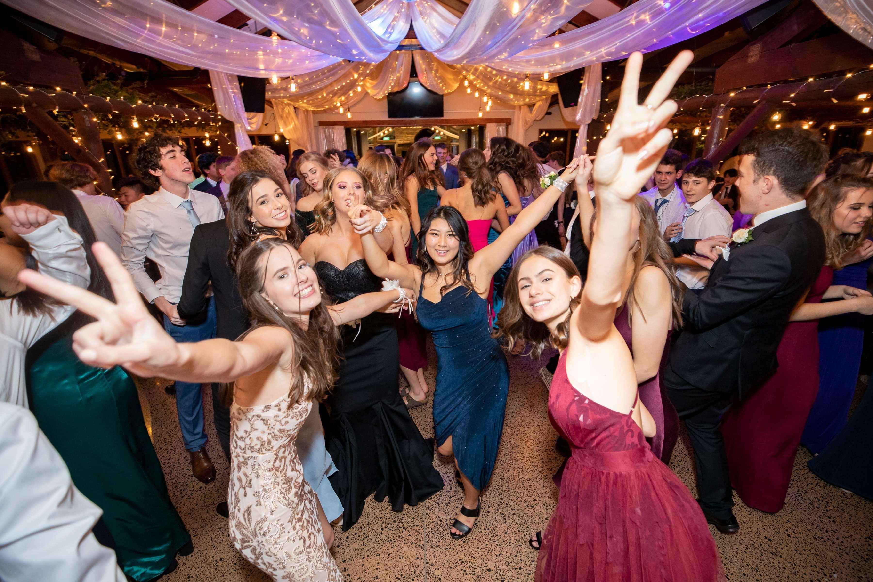 a group of girls dancing at school ball