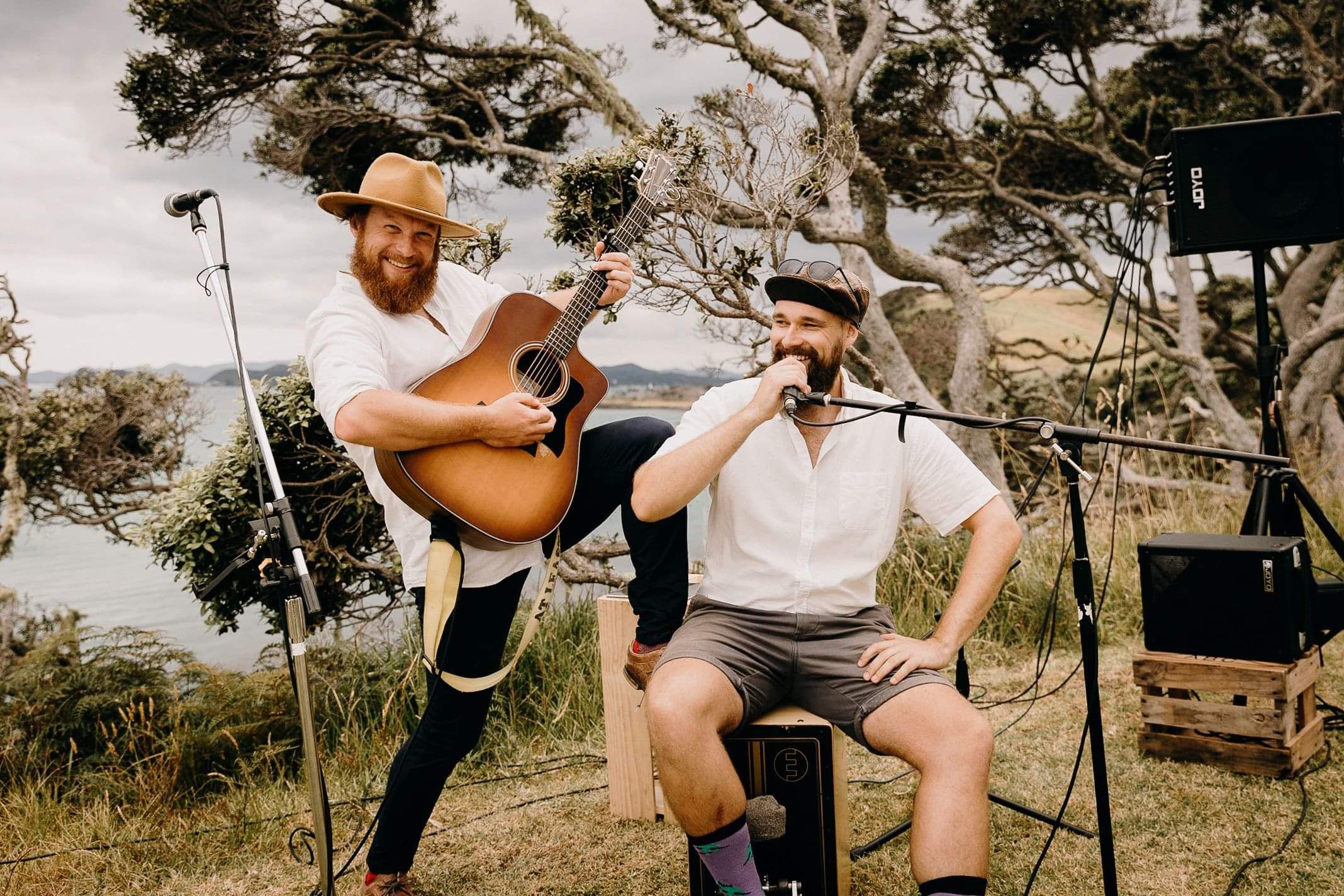 acoustic duo posing outdoors