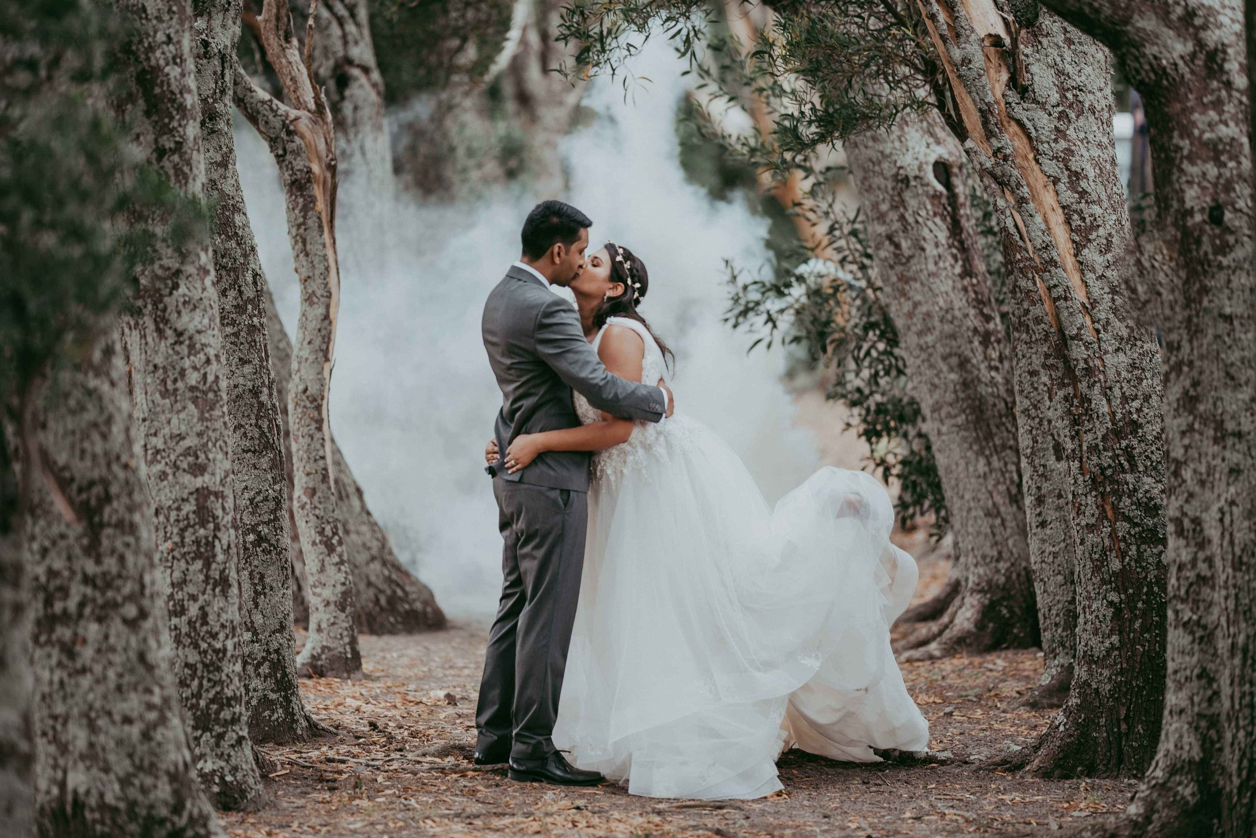 bride and groom kissing outdoors