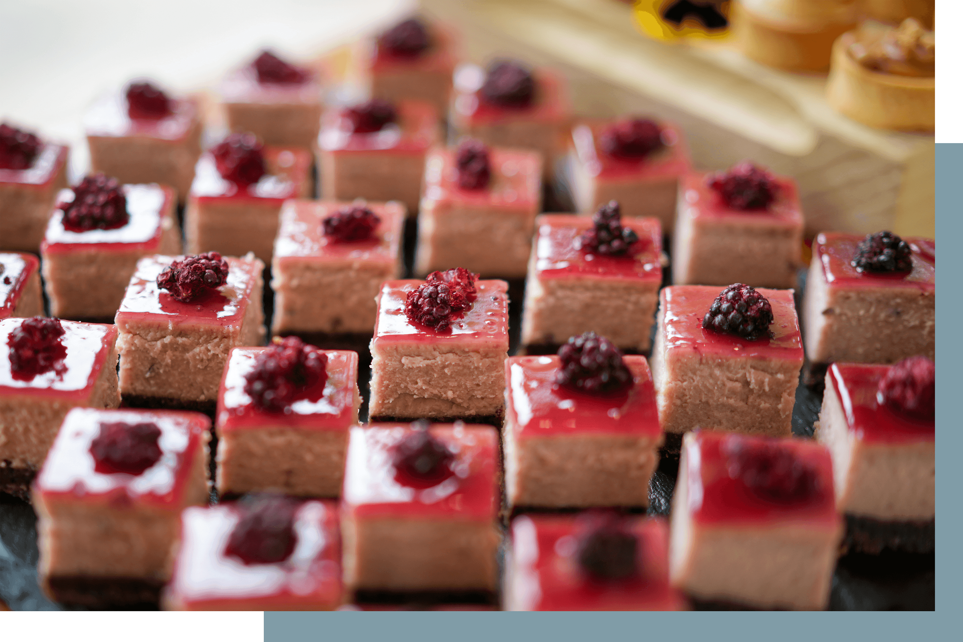 square raspberry mini cakes on a platter
