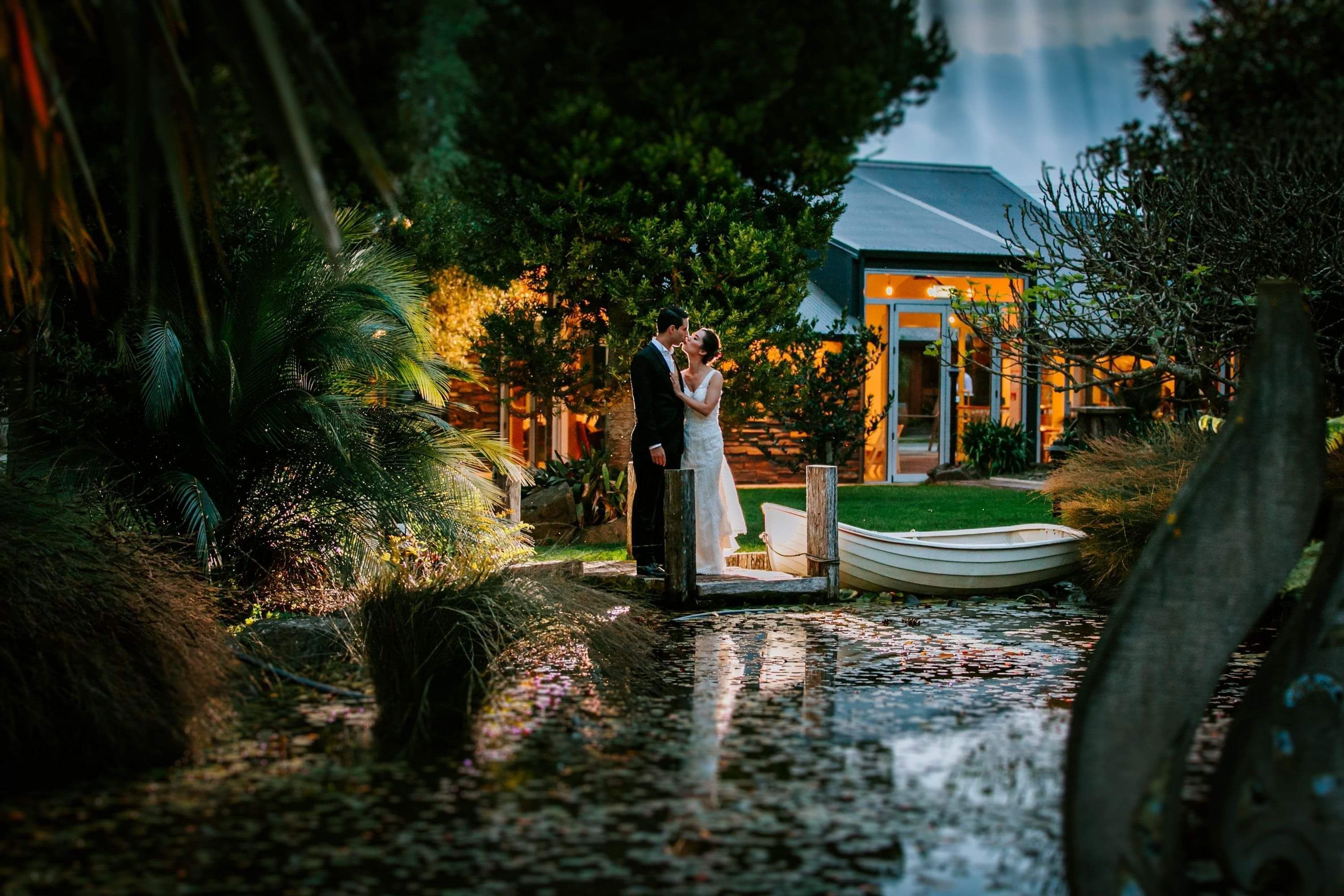 Markovina Vineyard Estate Wedding Venue Happy Couple Kissing by the Pond