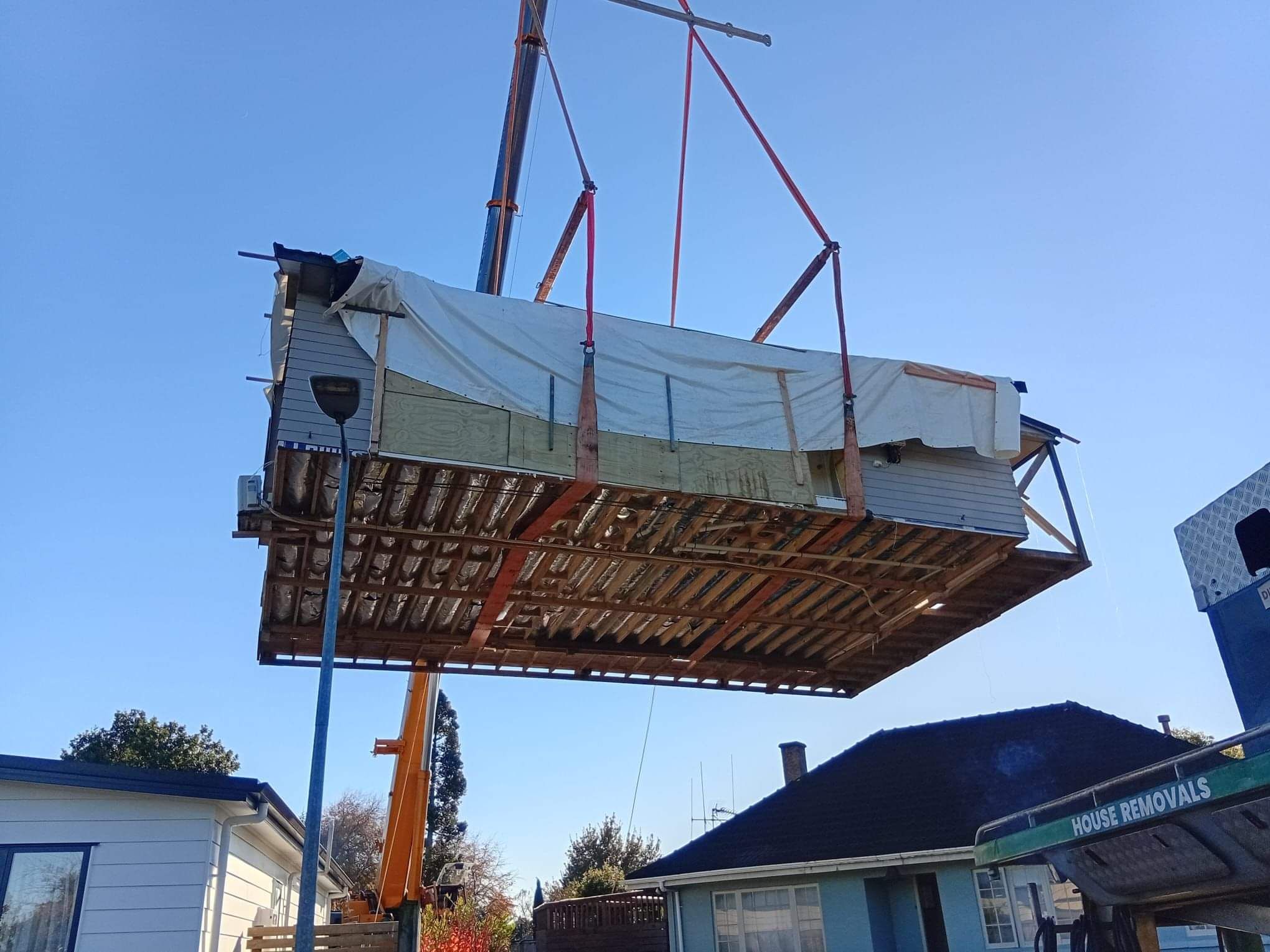 Relocated house set down safely on its new site after the crane lift