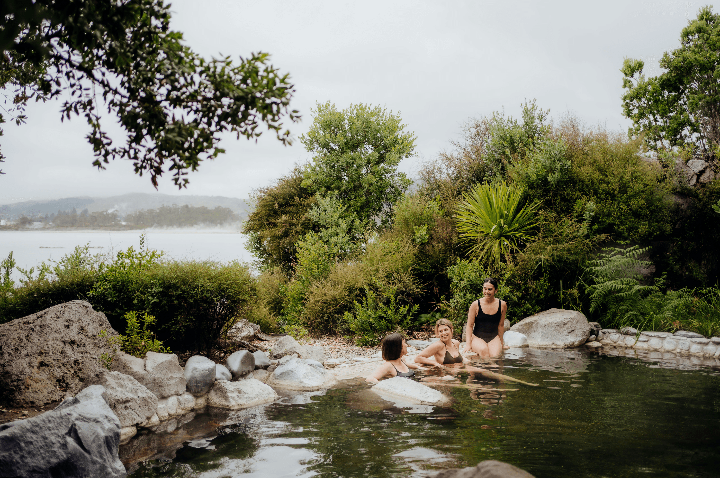 Couple relaxing in a hot pool at Polynesian Spa as part of the Glow and Soak combo in Rotorua