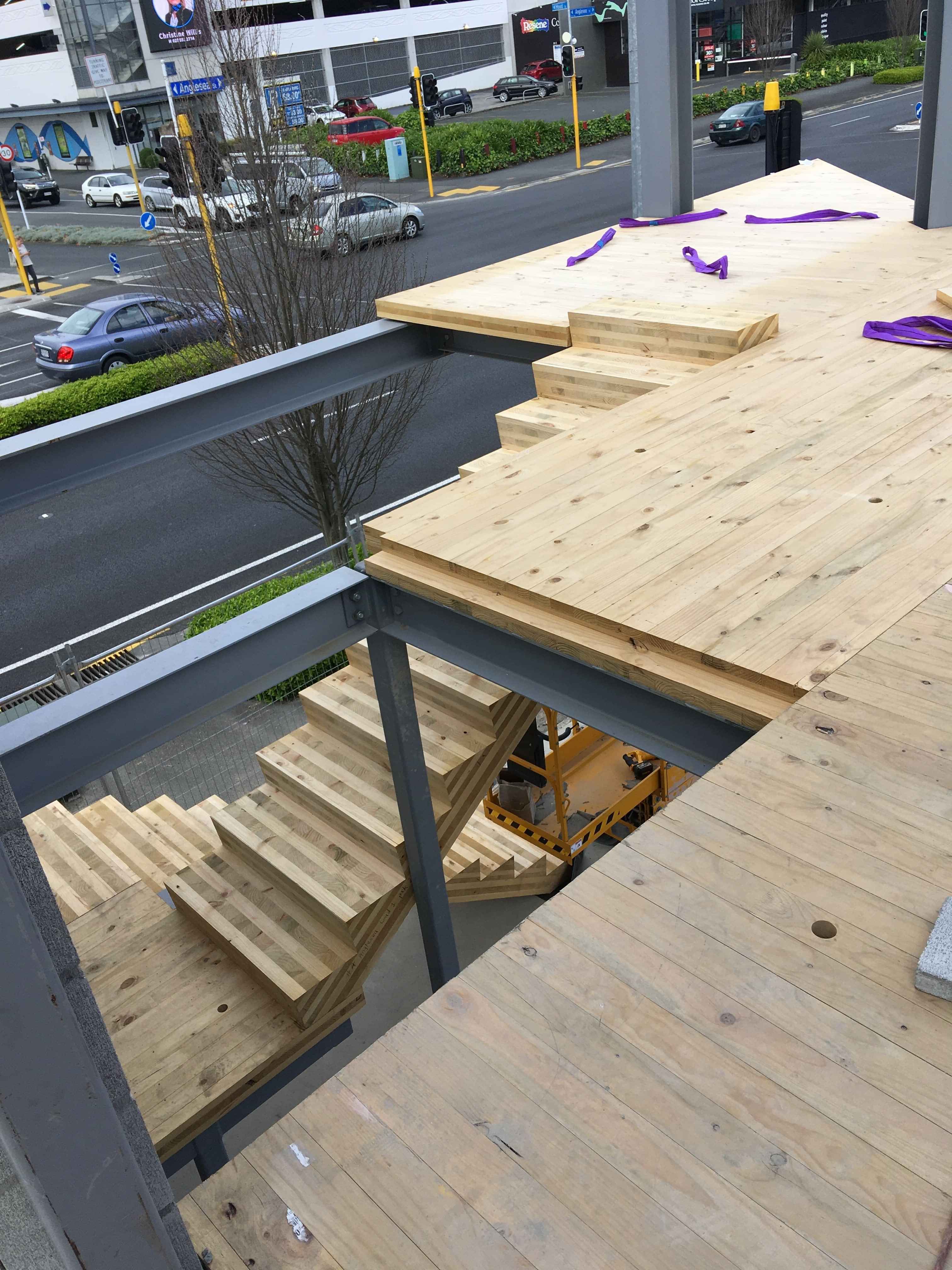 Modern waiting room with blue couch, round coffee table with plant, white vase, and painting on the wall.