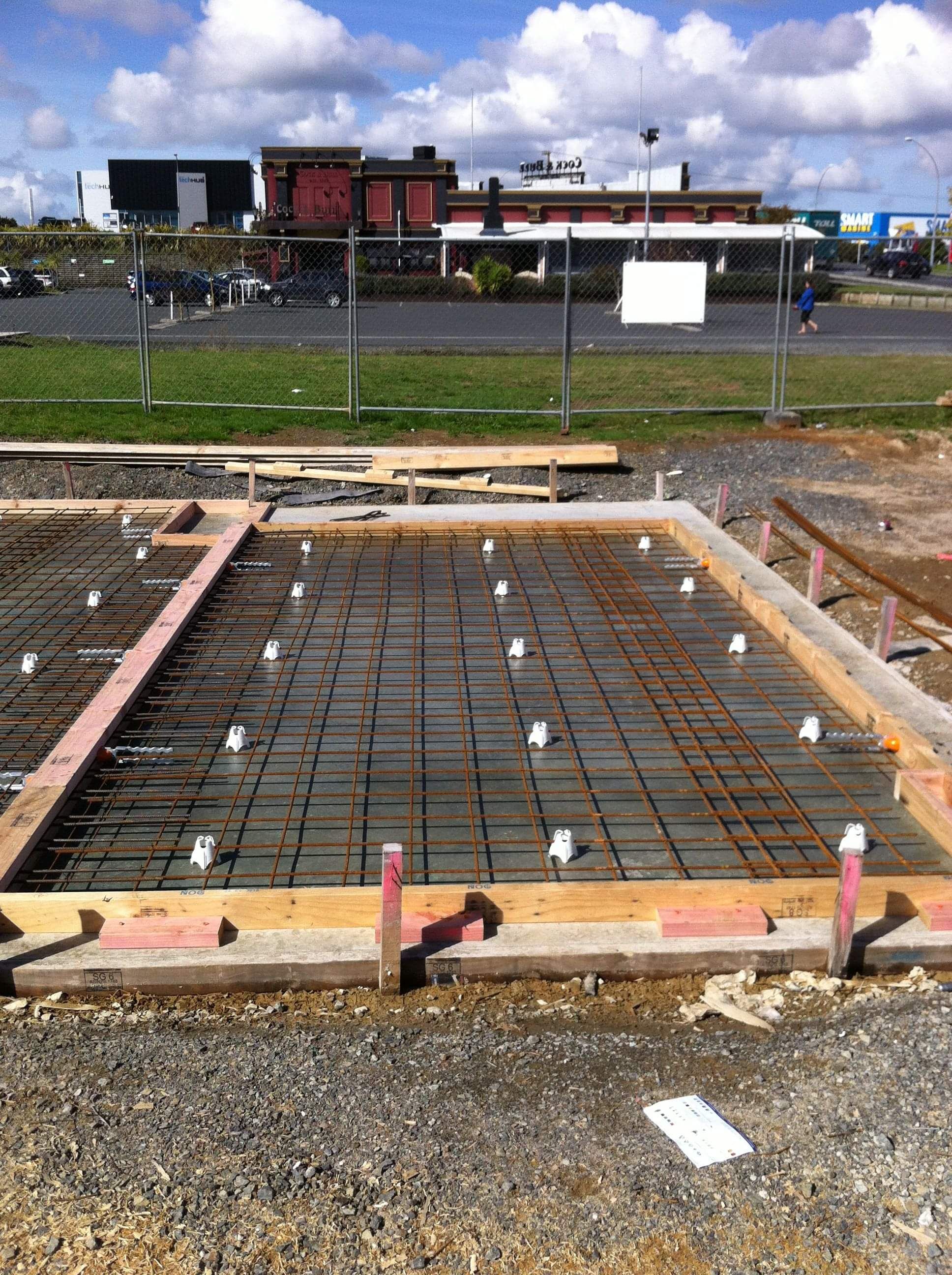 Modern waiting room with blue couch, round coffee table with plant, white vase, and painting on the wall.