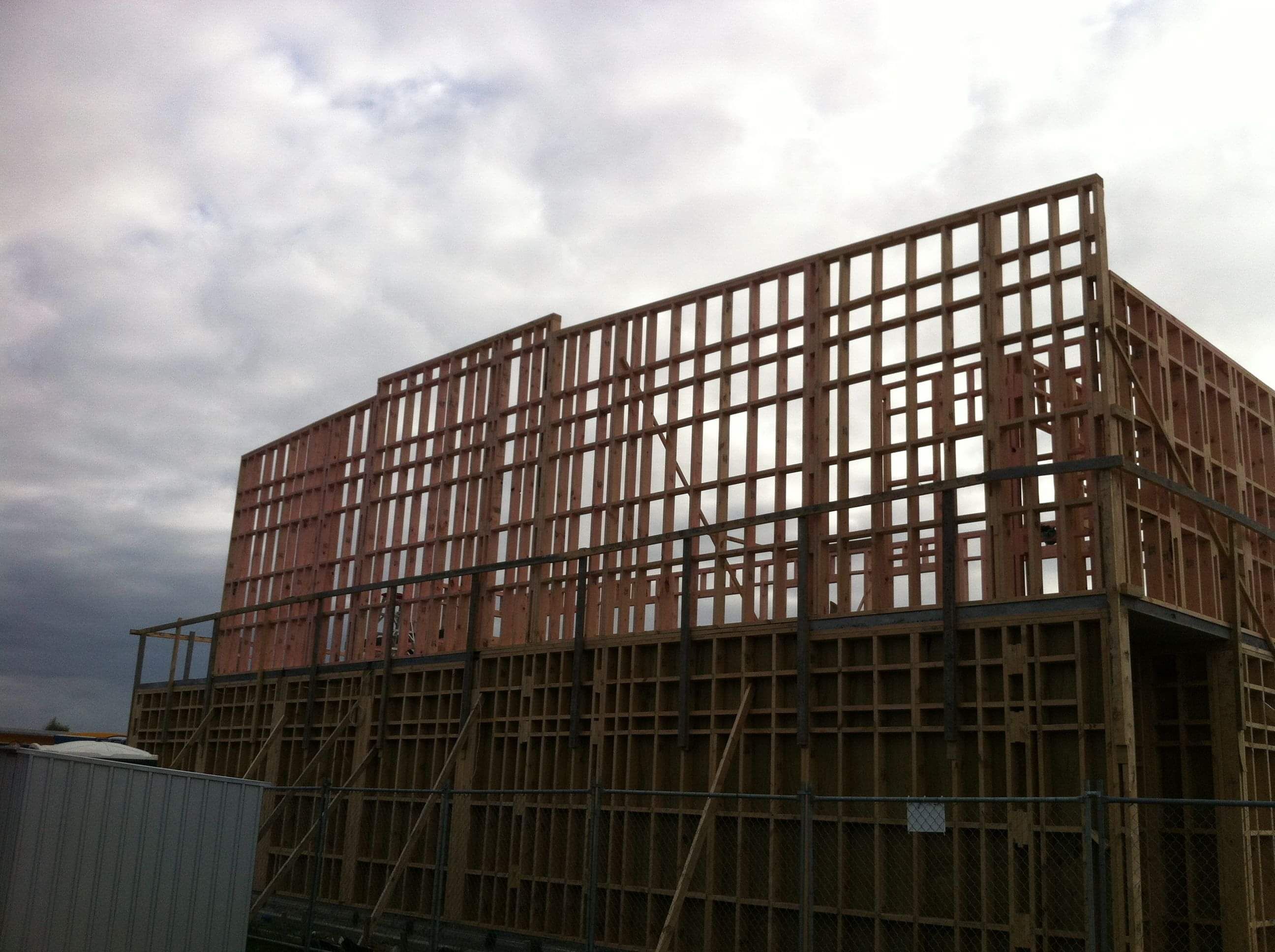 Modern waiting room with blue couch, round coffee table with plant, white vase, and painting on the wall.