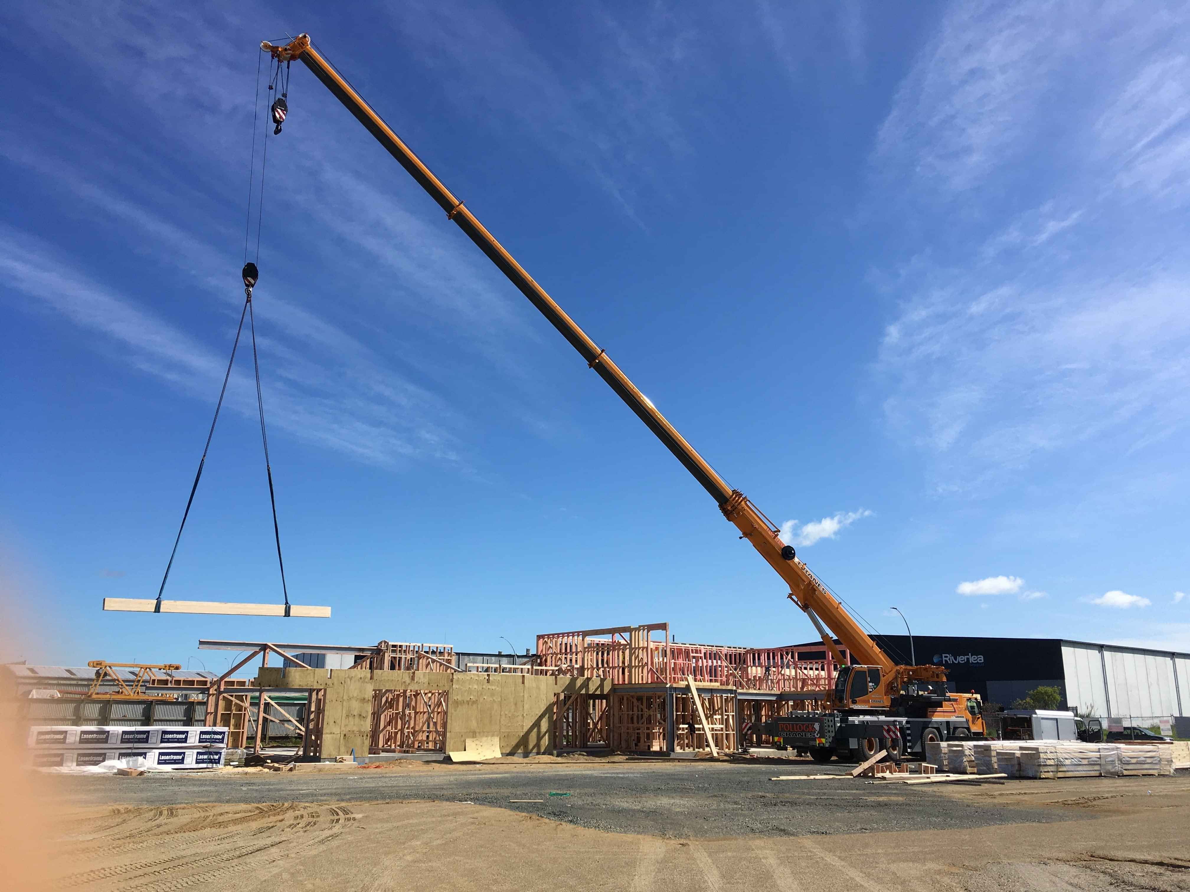 Modern waiting room with blue couch, round coffee table with plant, white vase, and painting on the wall.