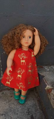 Red pinafore dress, reindeer print, fits 46cm doll