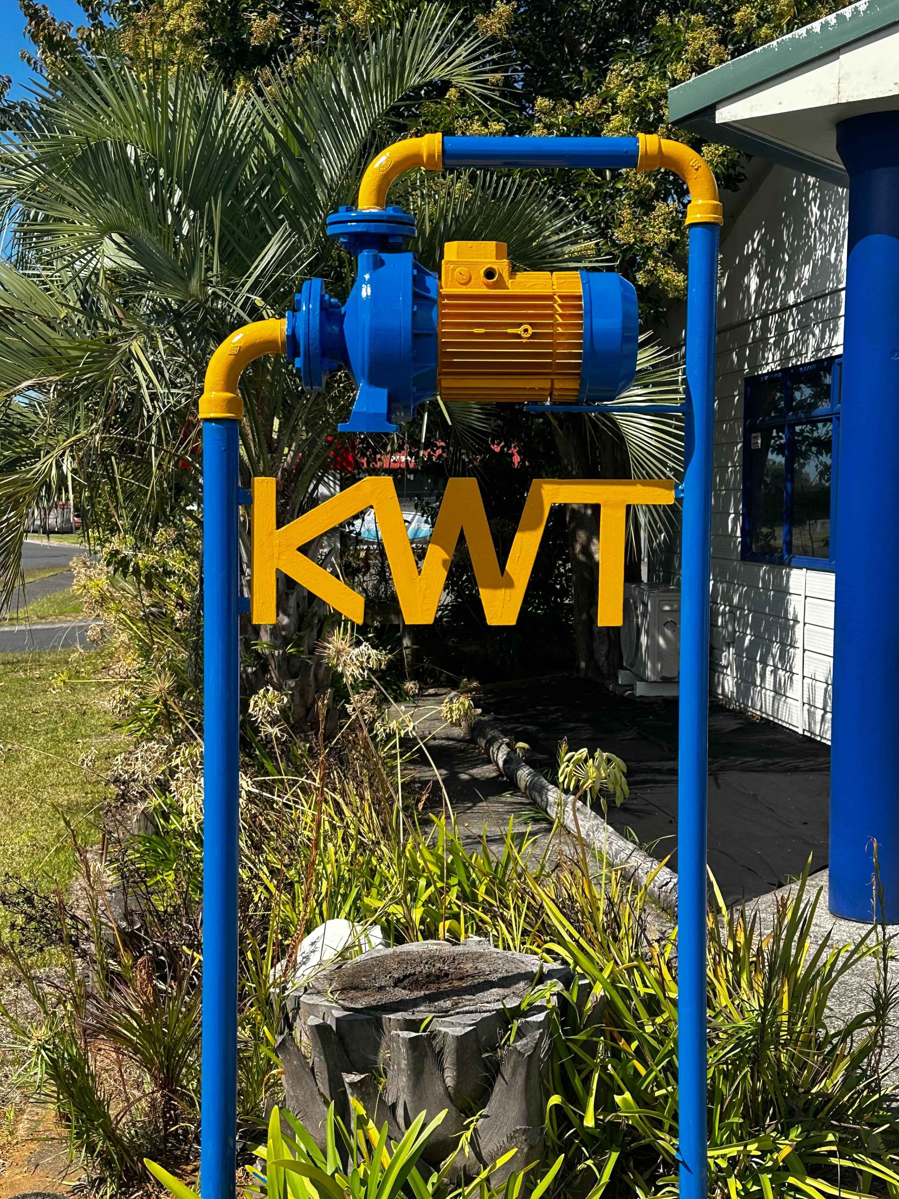 Photo of Katikati Water Pump logo at front of shop. Sign is made from pipes and a water pump