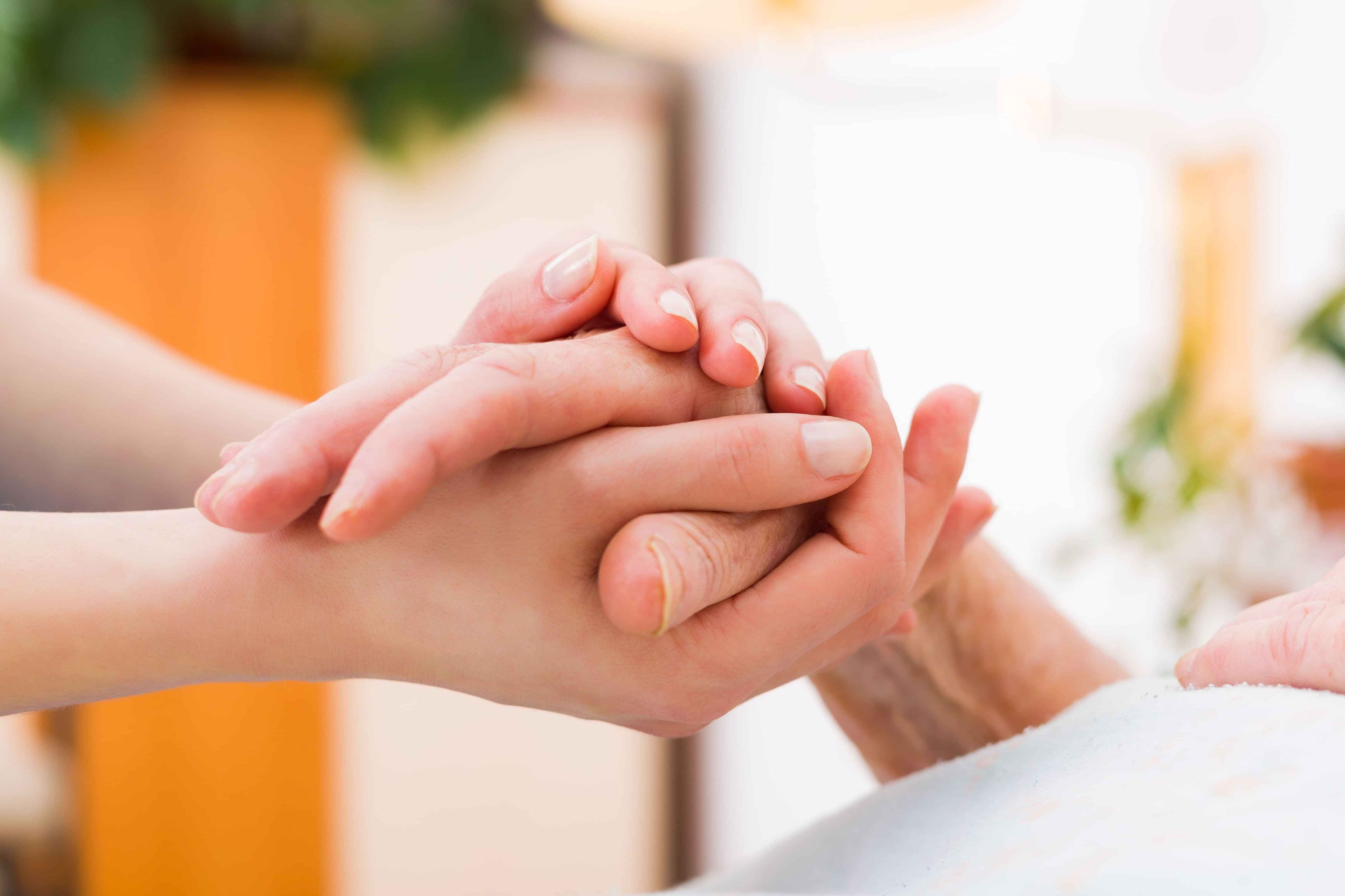 Nurse holding a residents hand at Tamahere Eventide Residential Care