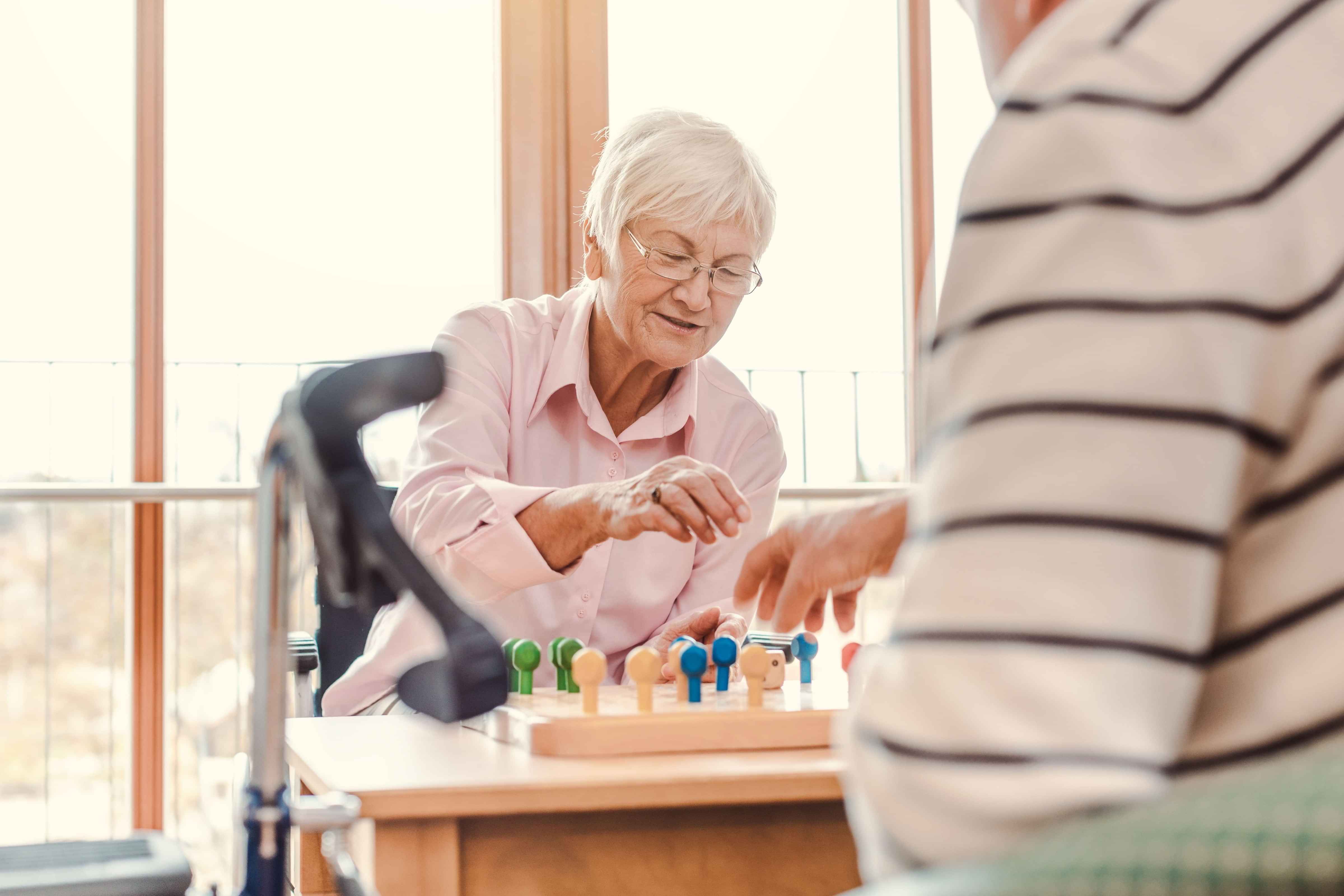 Residents playing board games at Atawhai Assisi day programme
