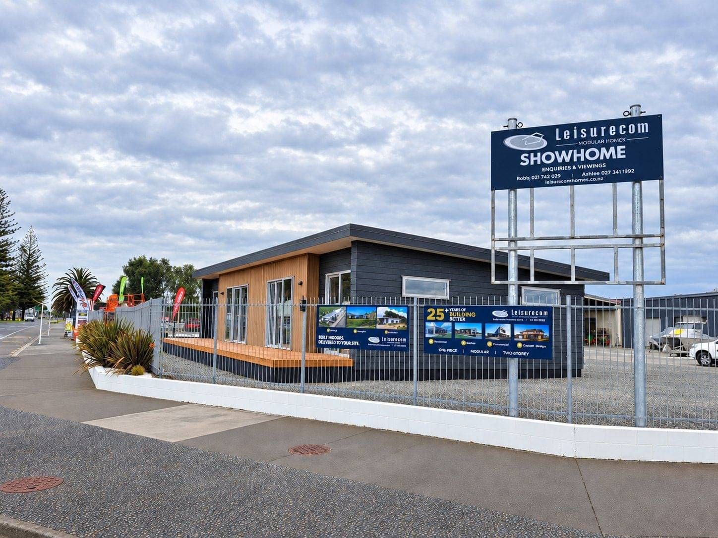 Leisurecom Showhome sign beside the Napier show home at dusk