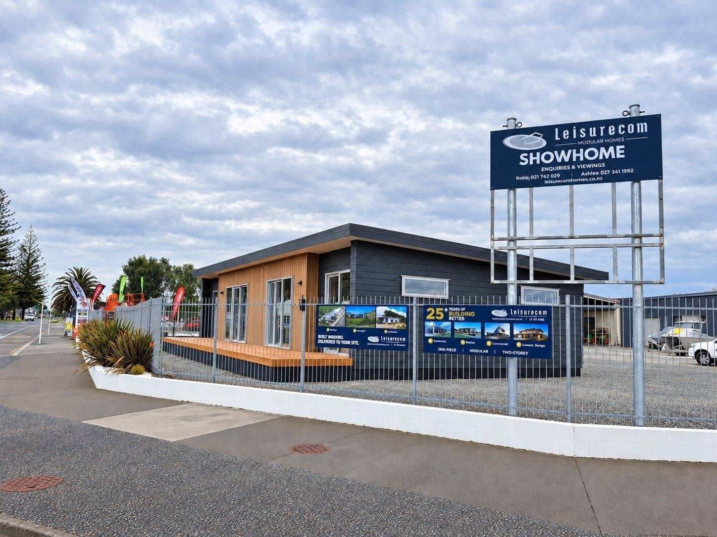 Leisurecom Showhome sign beside the Napier show home at dusk