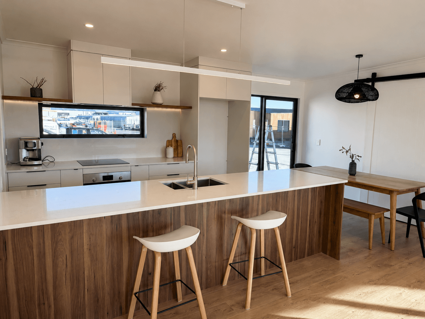 Te Mata show home kitchen with island bench, timber-look cabinetry and dining space