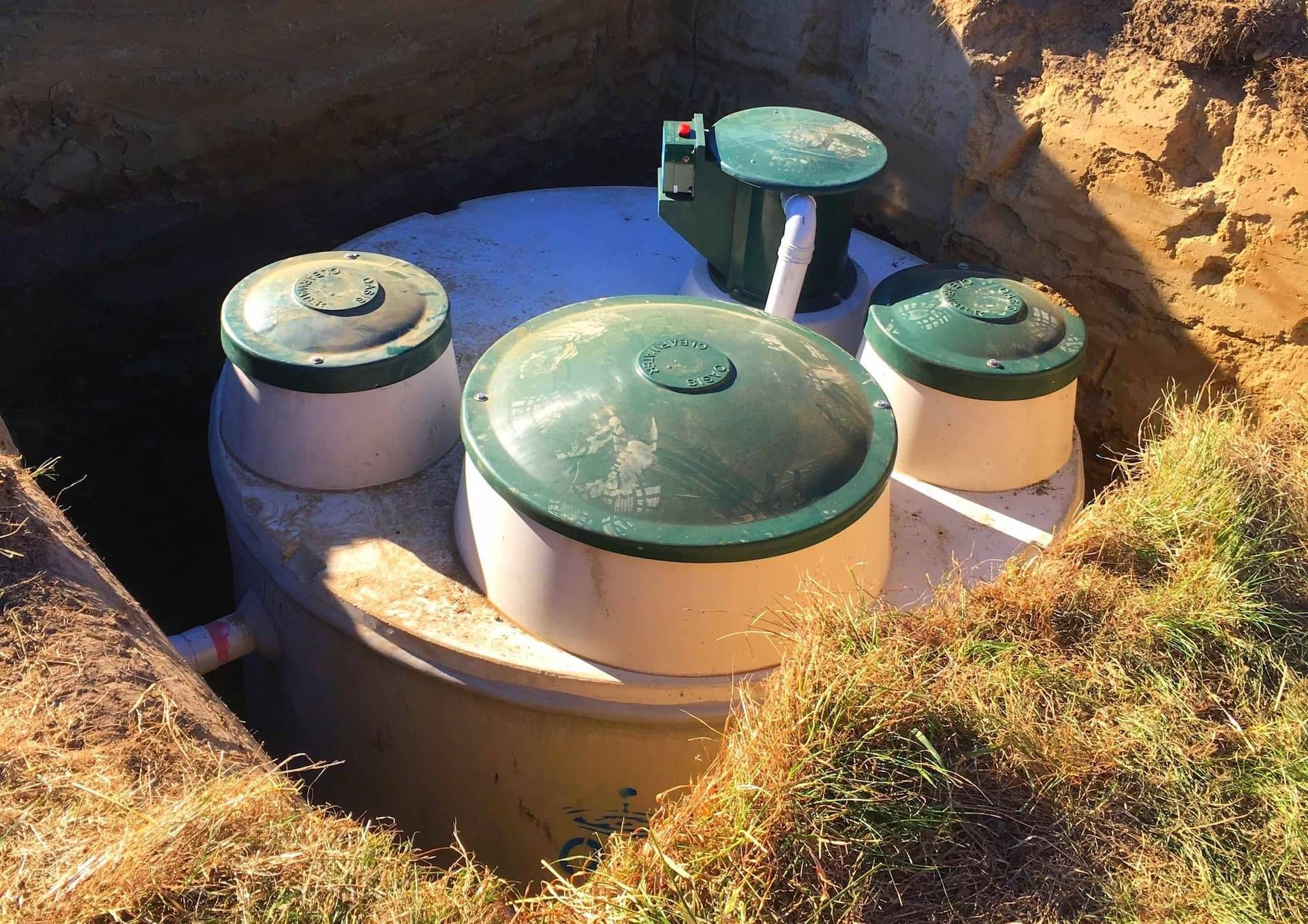 septic tank being set into ground by Drainpro