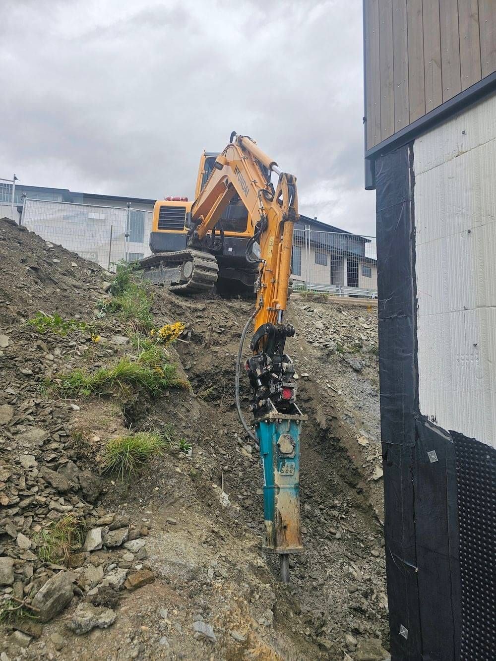 A machine at work breaking up rock on a section in Queenstown.