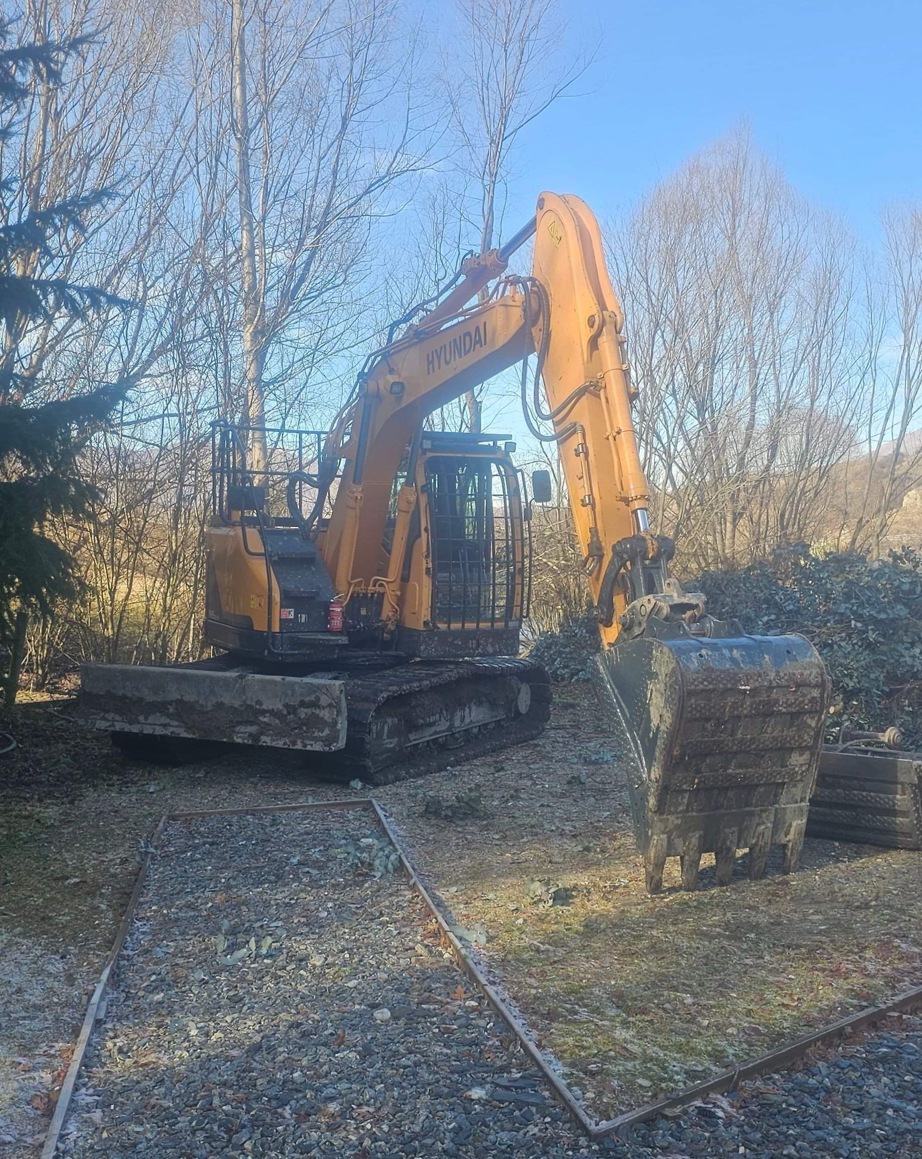 A large Concrete & Earth digger on site ready to begin landscaping.