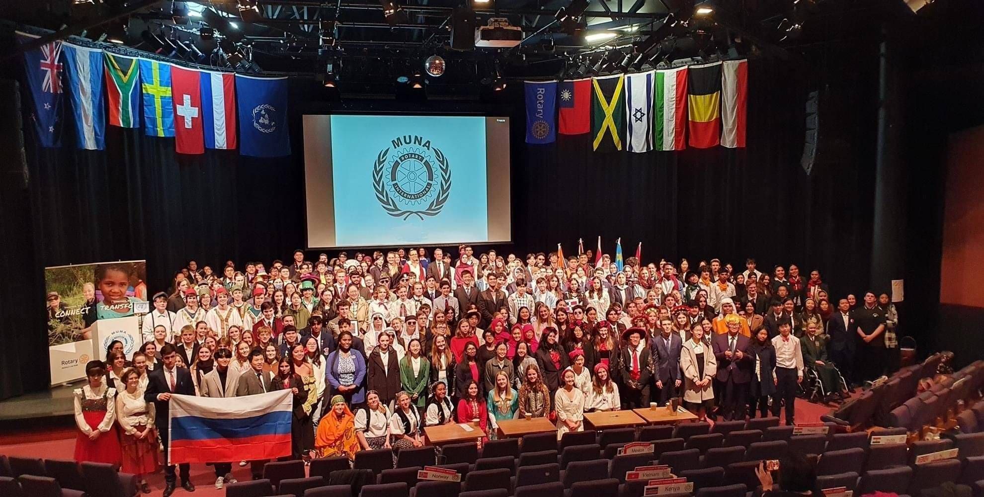 A large group photo of MUNA participants in their cultural attire