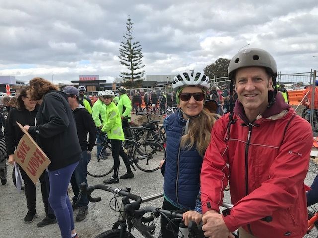 two people on bikes smiling at the camera