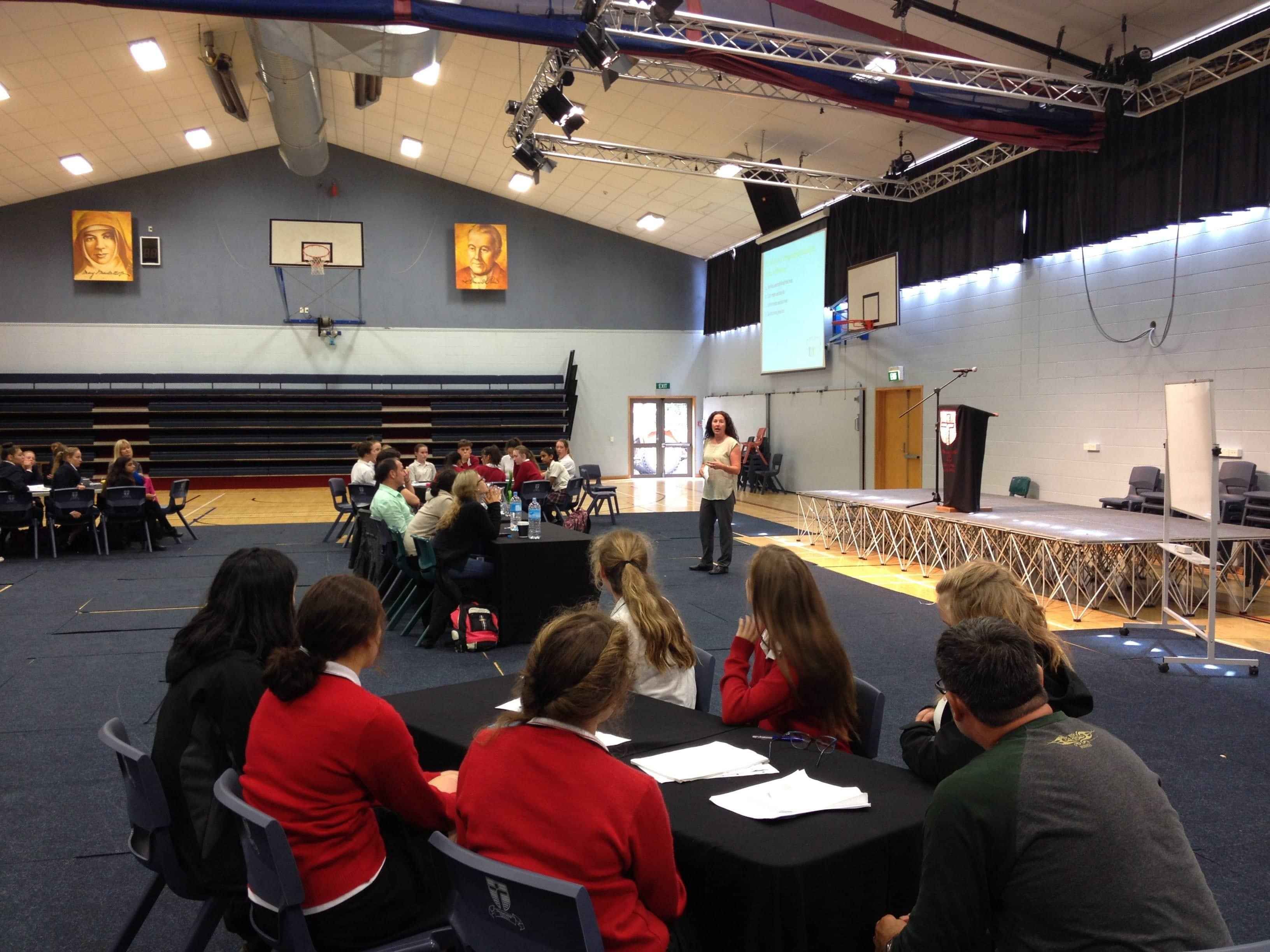 table of people watching a presenter 