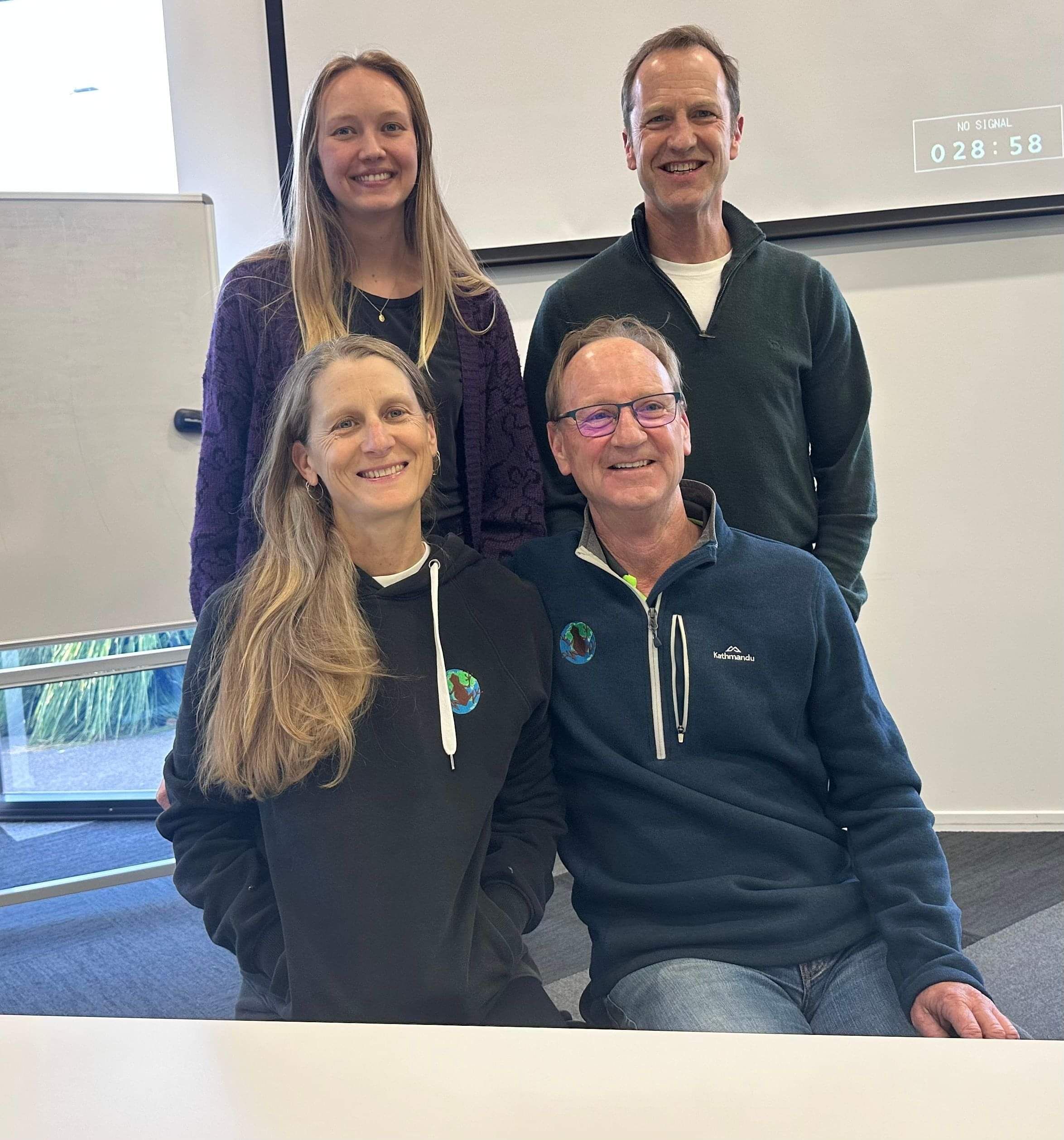 The four lead team smiling for group photo