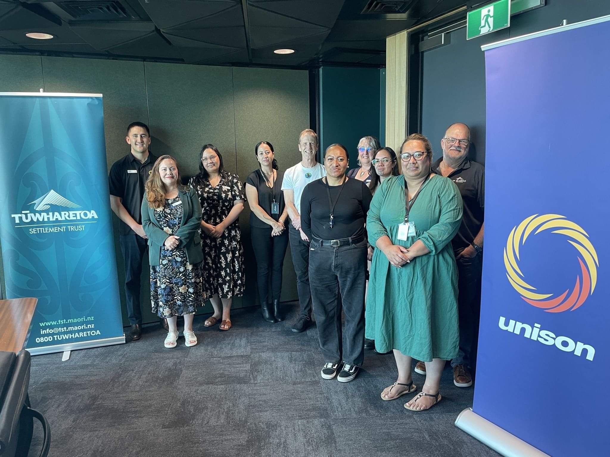 Team members posing together at a professional awards or recognition event