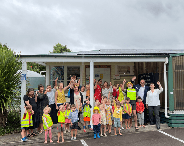 Children and teachers gathered outside an early childhood education centre for a group photo