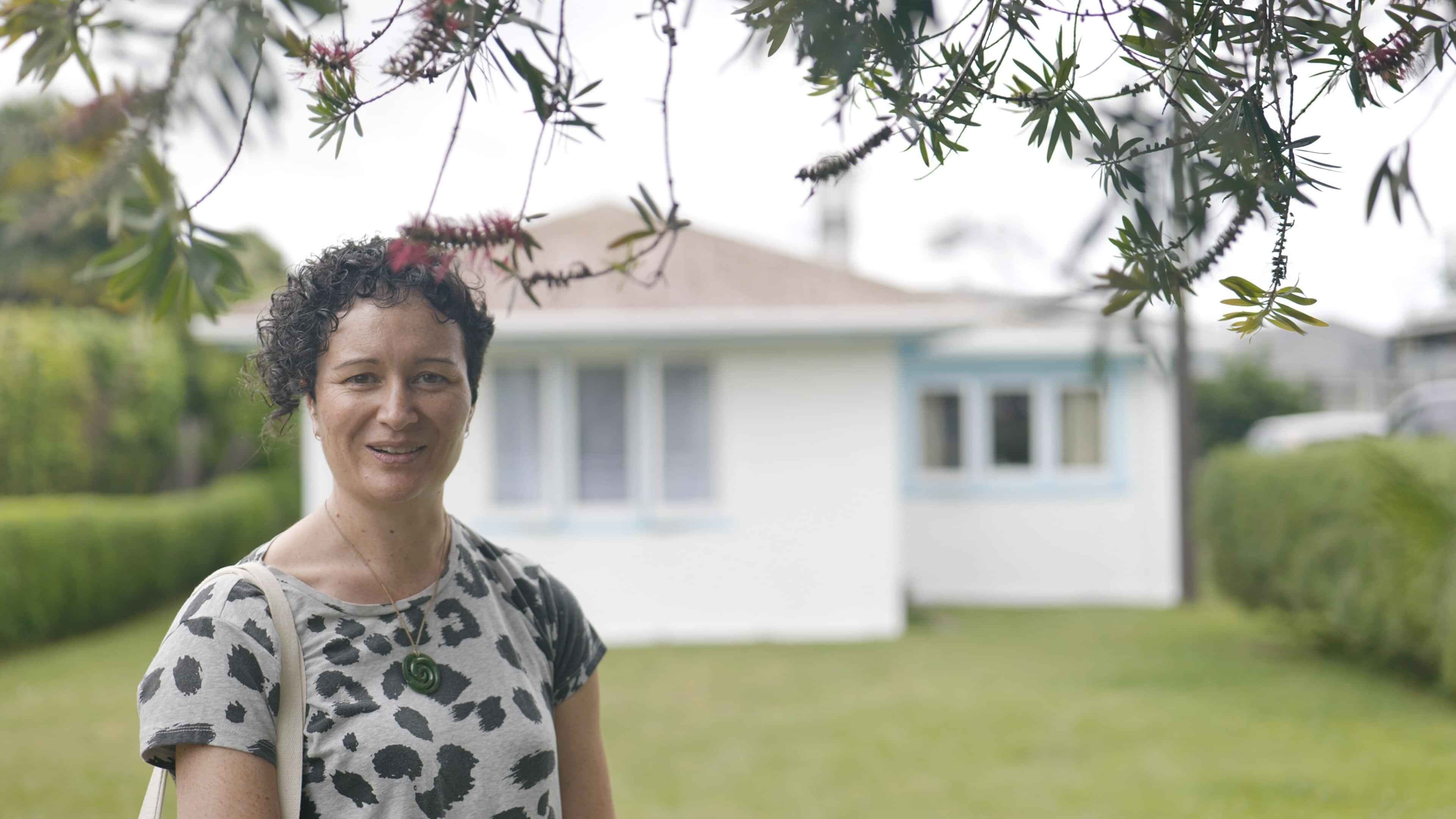 Woman standing in front of house