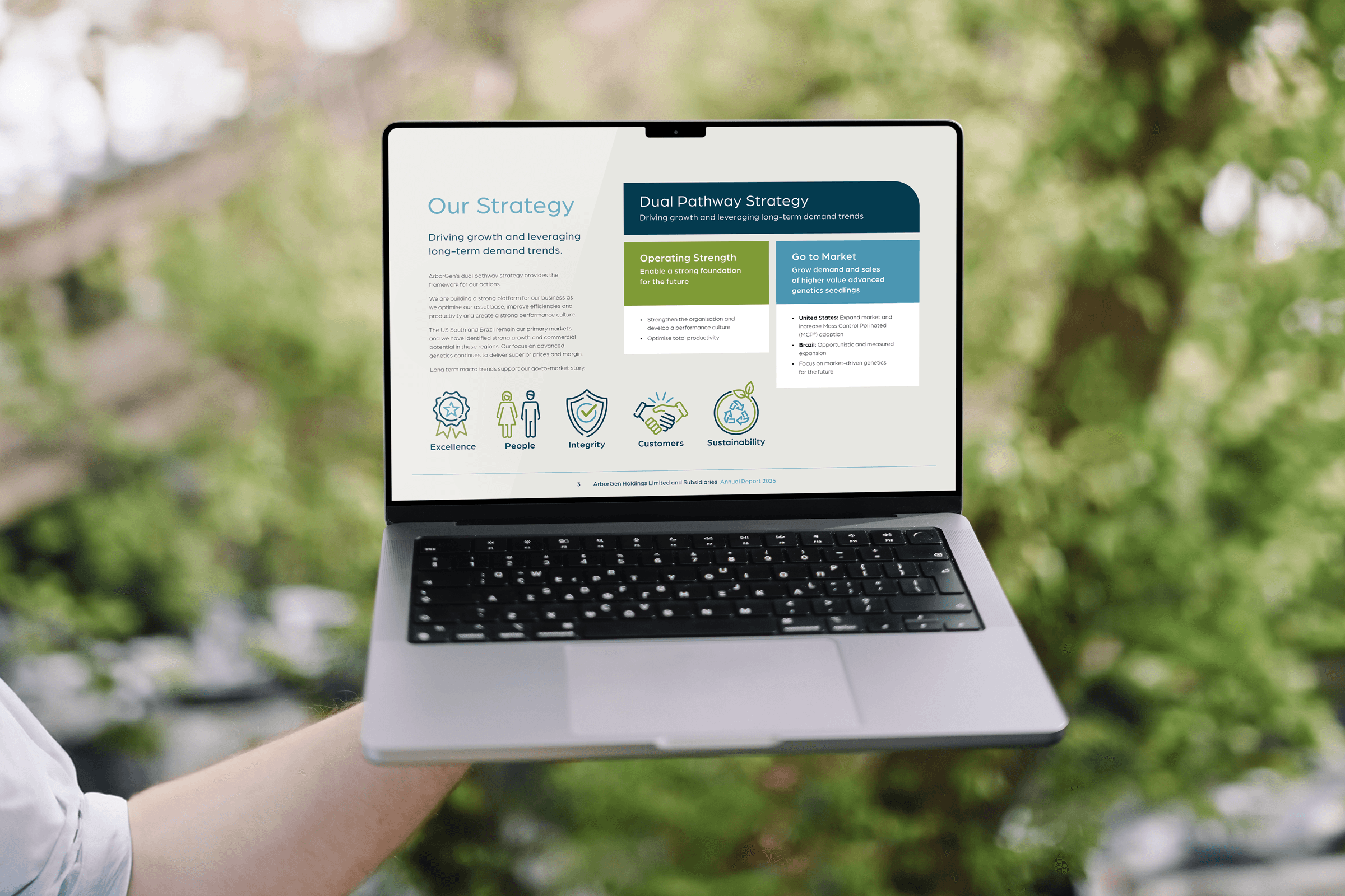 single page from annual report displayed digitally full screen on a laptop with trees in the background.