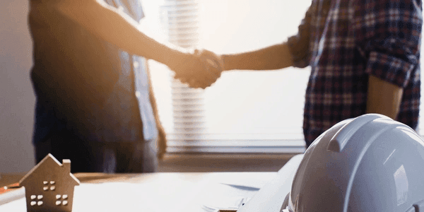 Two business owners sealing the deal with clear Terms of Trade. This ensures payment terms are well defined. Get paid on time