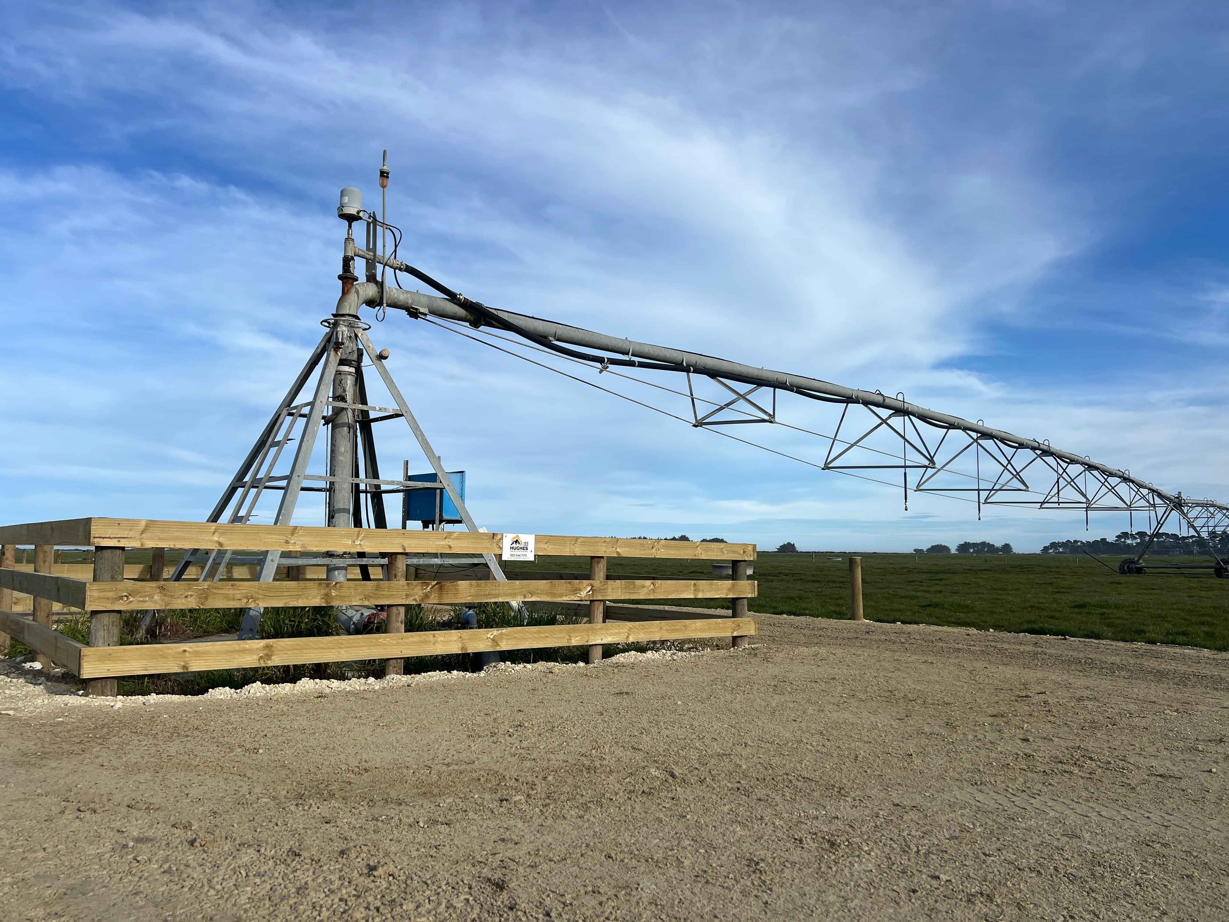 Post and rail fence around a centre pivot