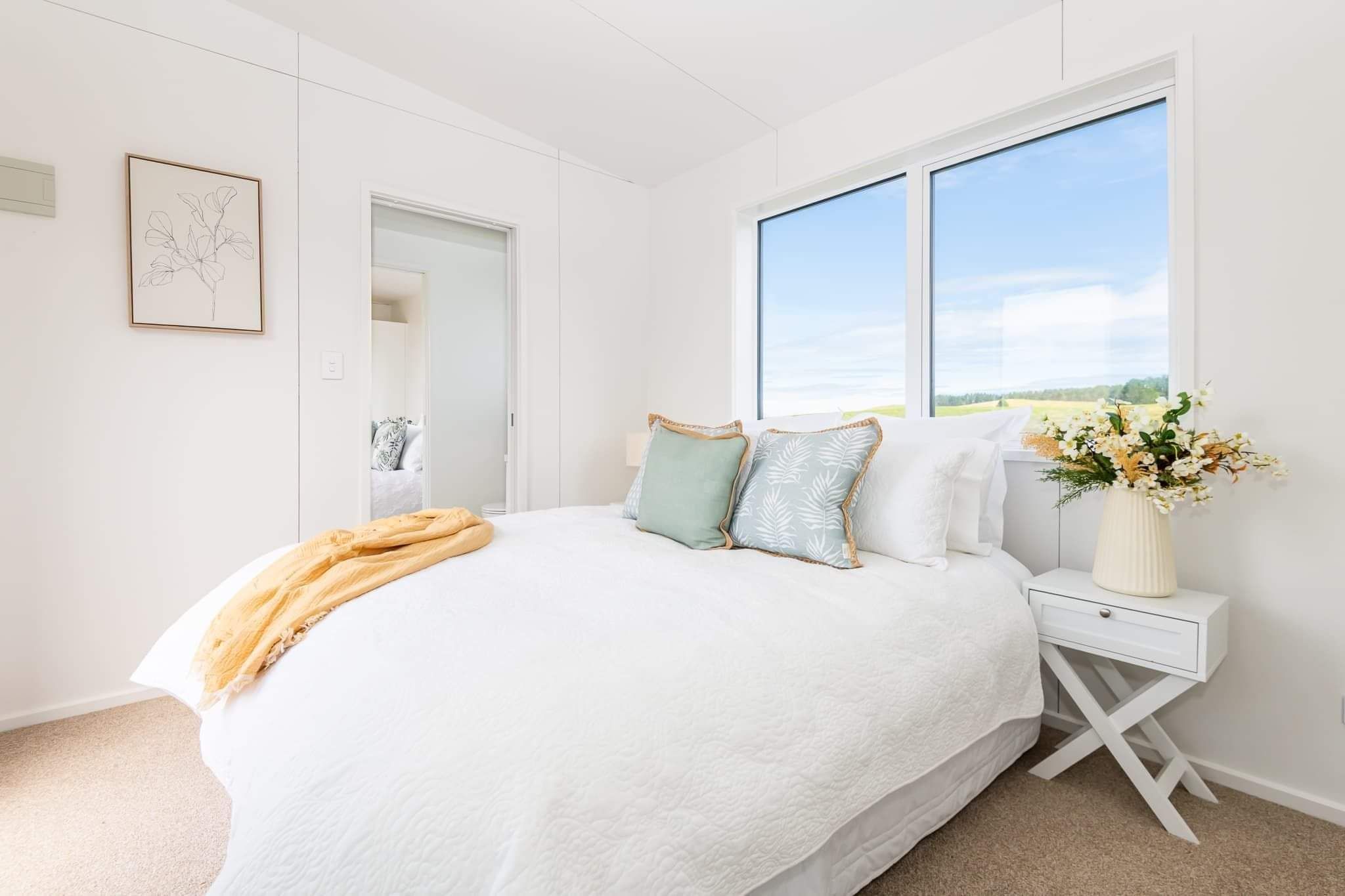 tiny home cabin msater bedroom with freshly made bed