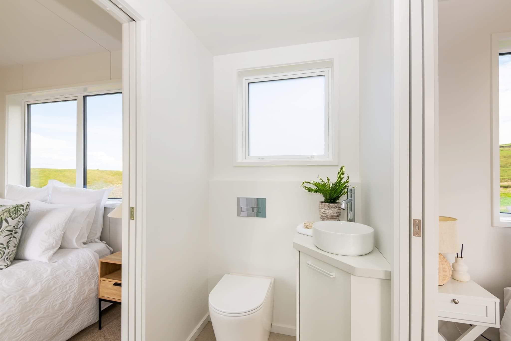 tiny home cabin bathroom with toilet and vanity