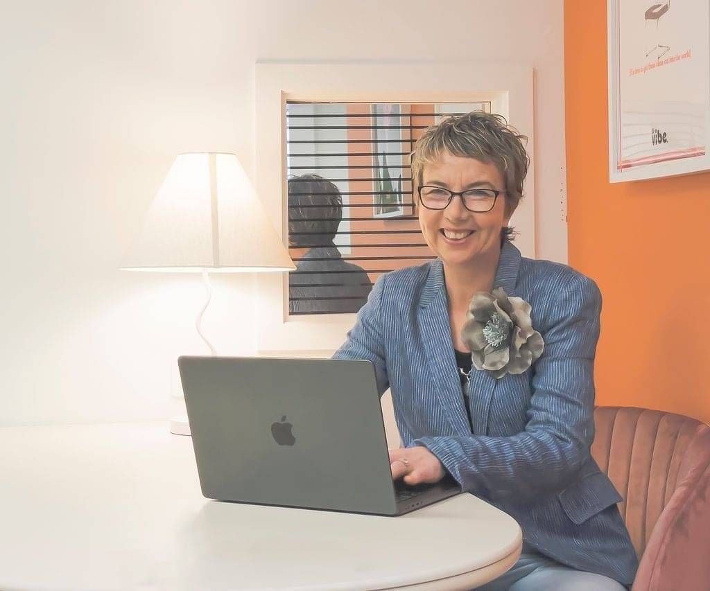 maree gately marketing strategist in whangarei nz sitting at a desk with laptop 