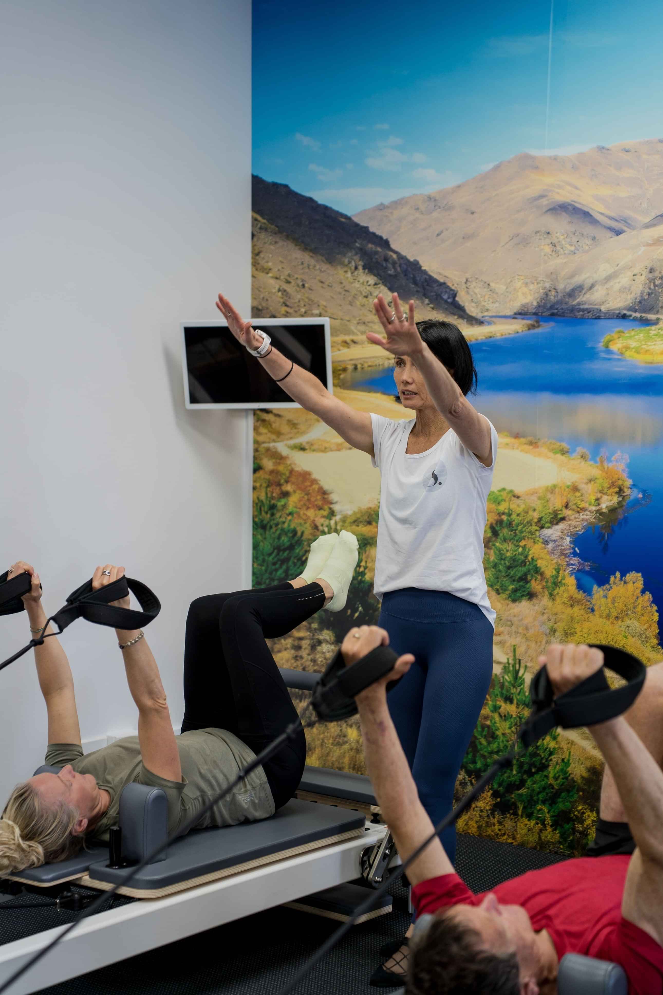 Image of instructor leading people on pilates reformer machines at Self, wellness studio in Alexandra.