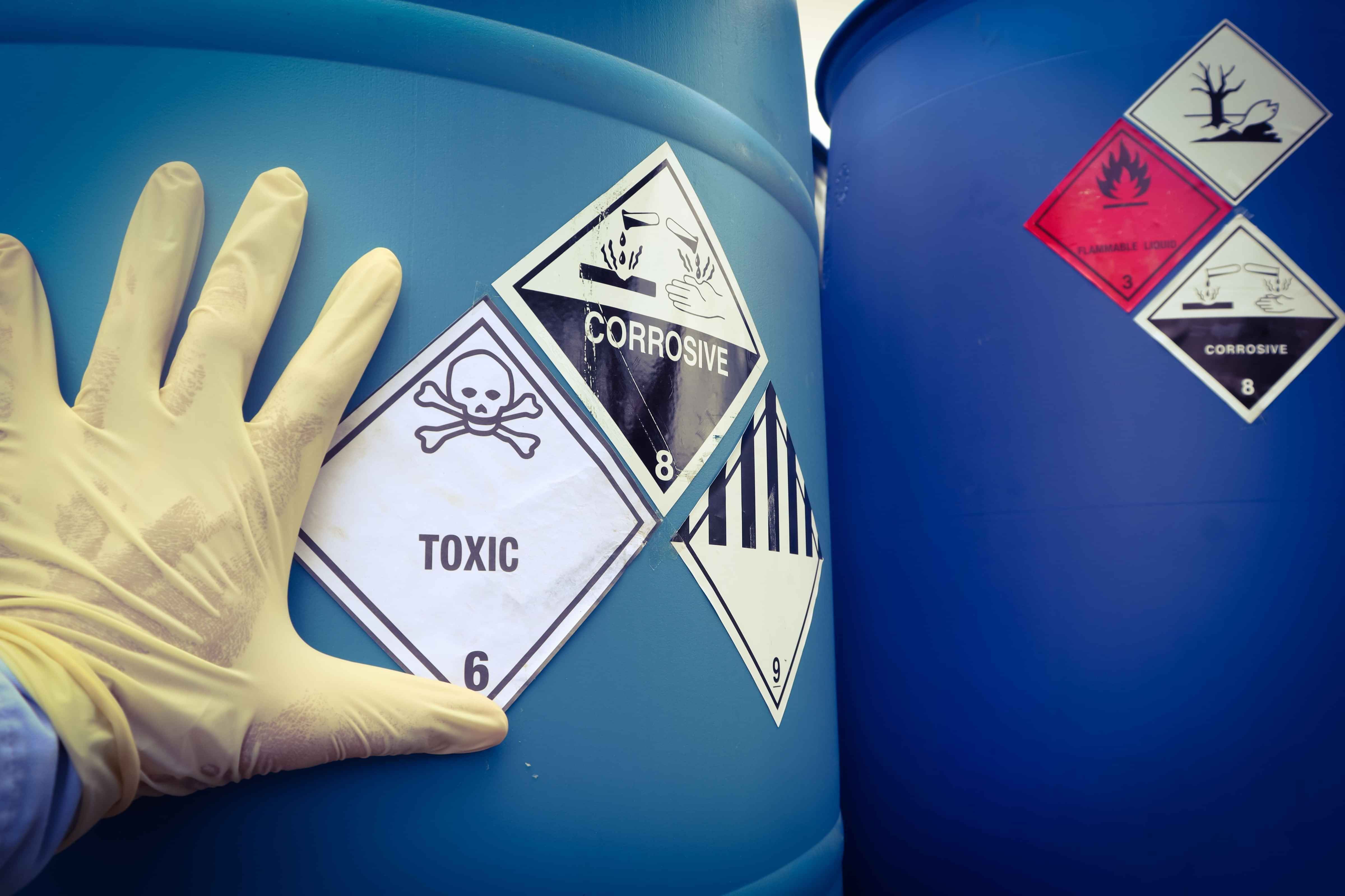 Chemical storage container with warning labels