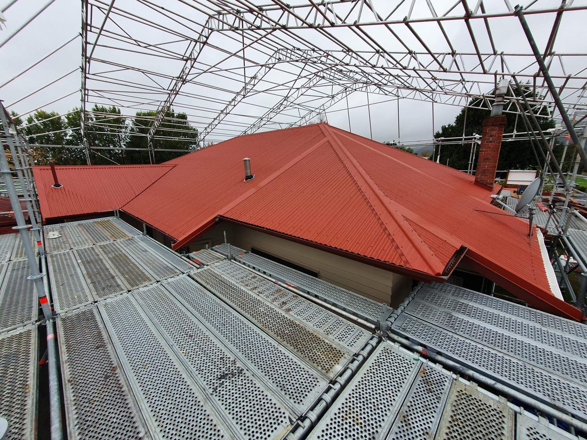 A house undergoing re-roofing in Hamilton with scaffolding in place
