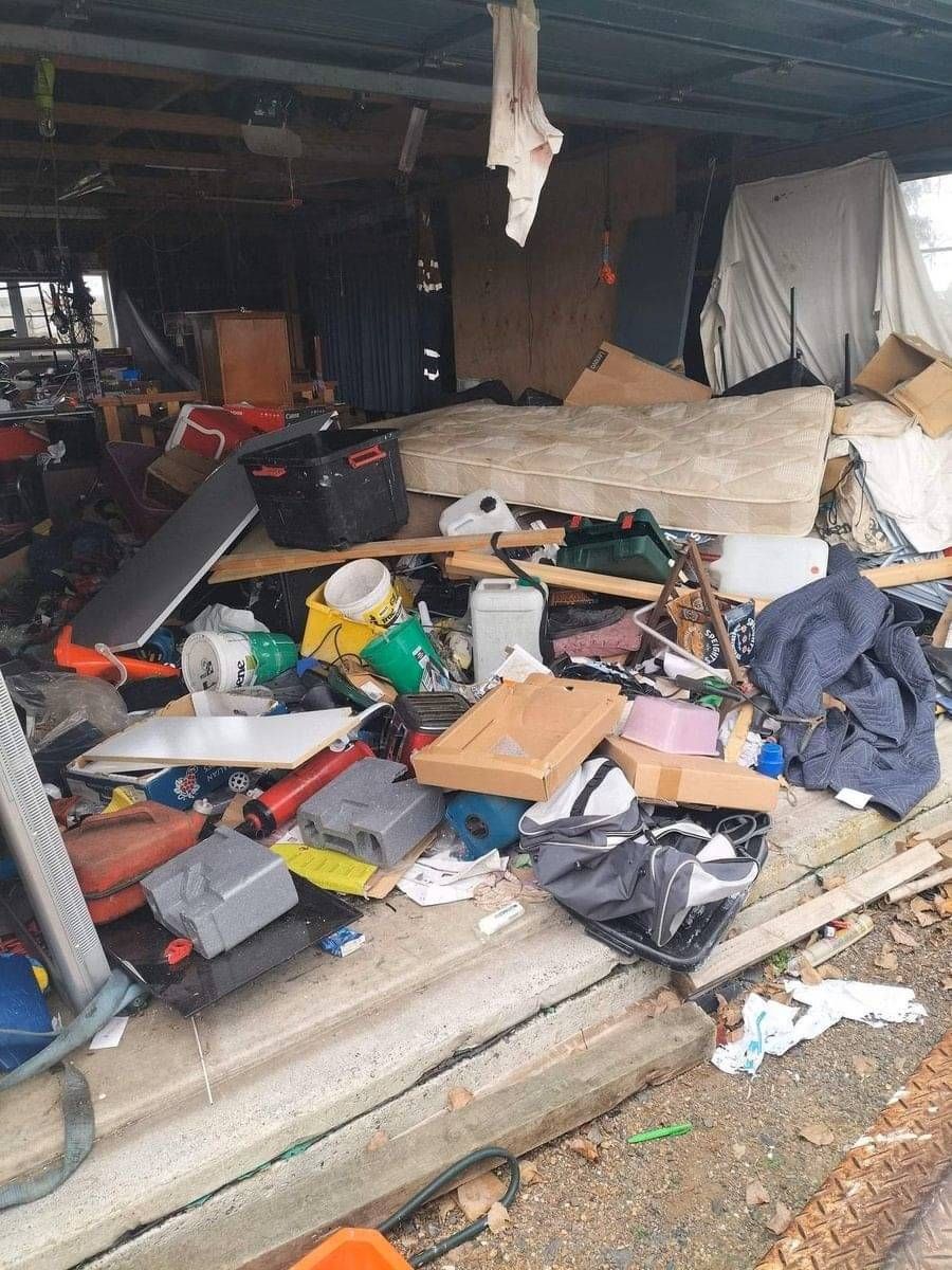 a mattress on top of a couch in a rubbish pile