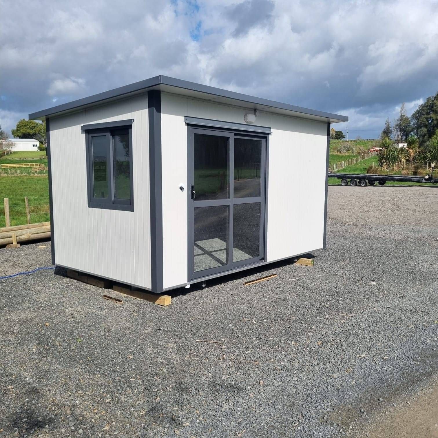 4.1m x 2.4m white cabin with window on the left short wall