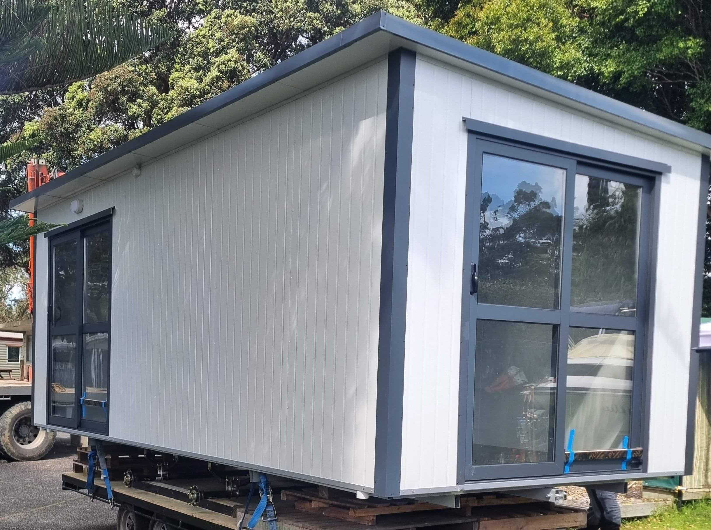 4.6m x 2.7m grey cabin with high window on the back wall